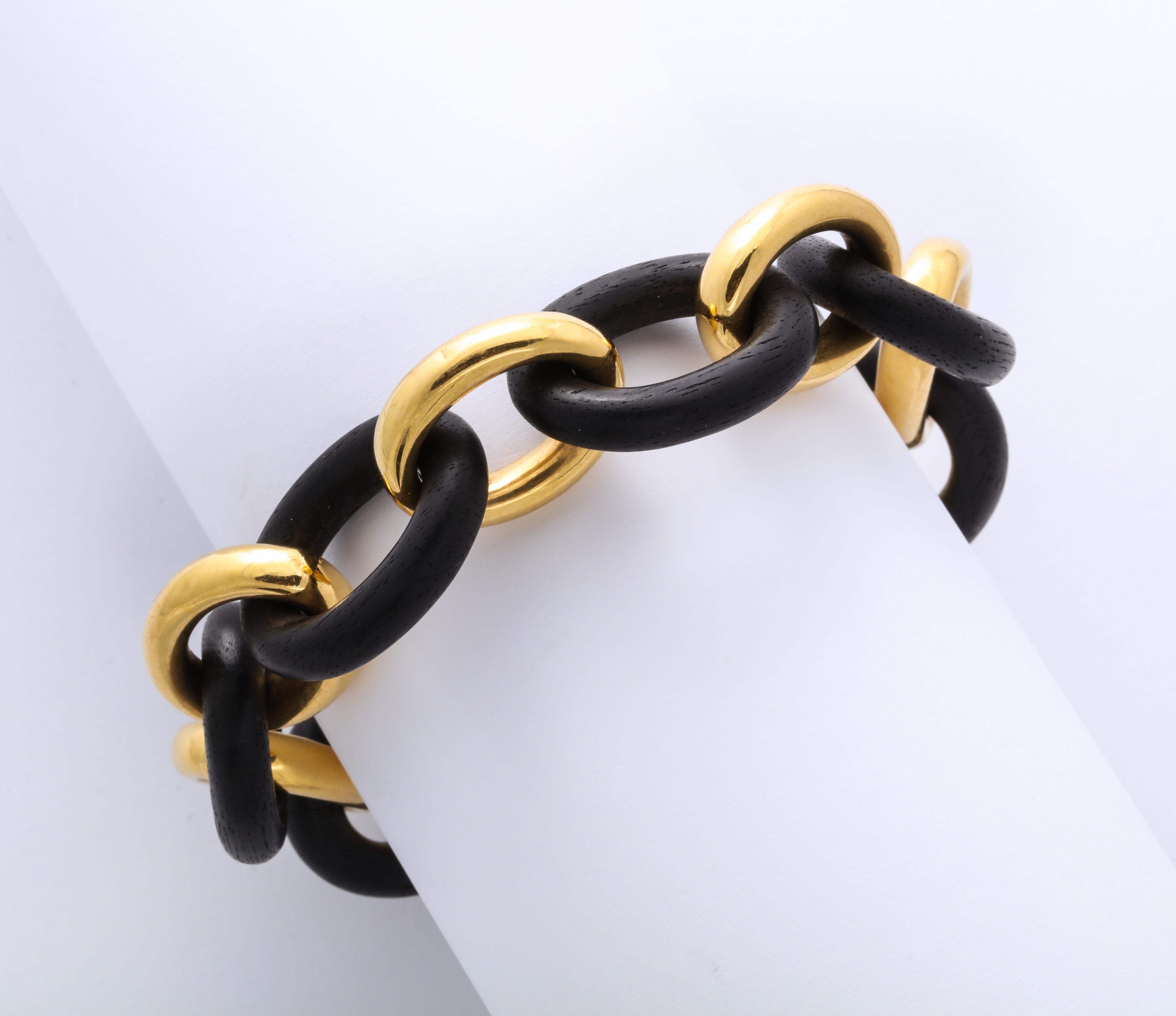 A stunning vintage classic petite link bracelet by Seaman Schepps. Hand carved links of ebony alternate with identical links of 18k yellow gold, embracing the classic mid-century look. Signed and numbered.