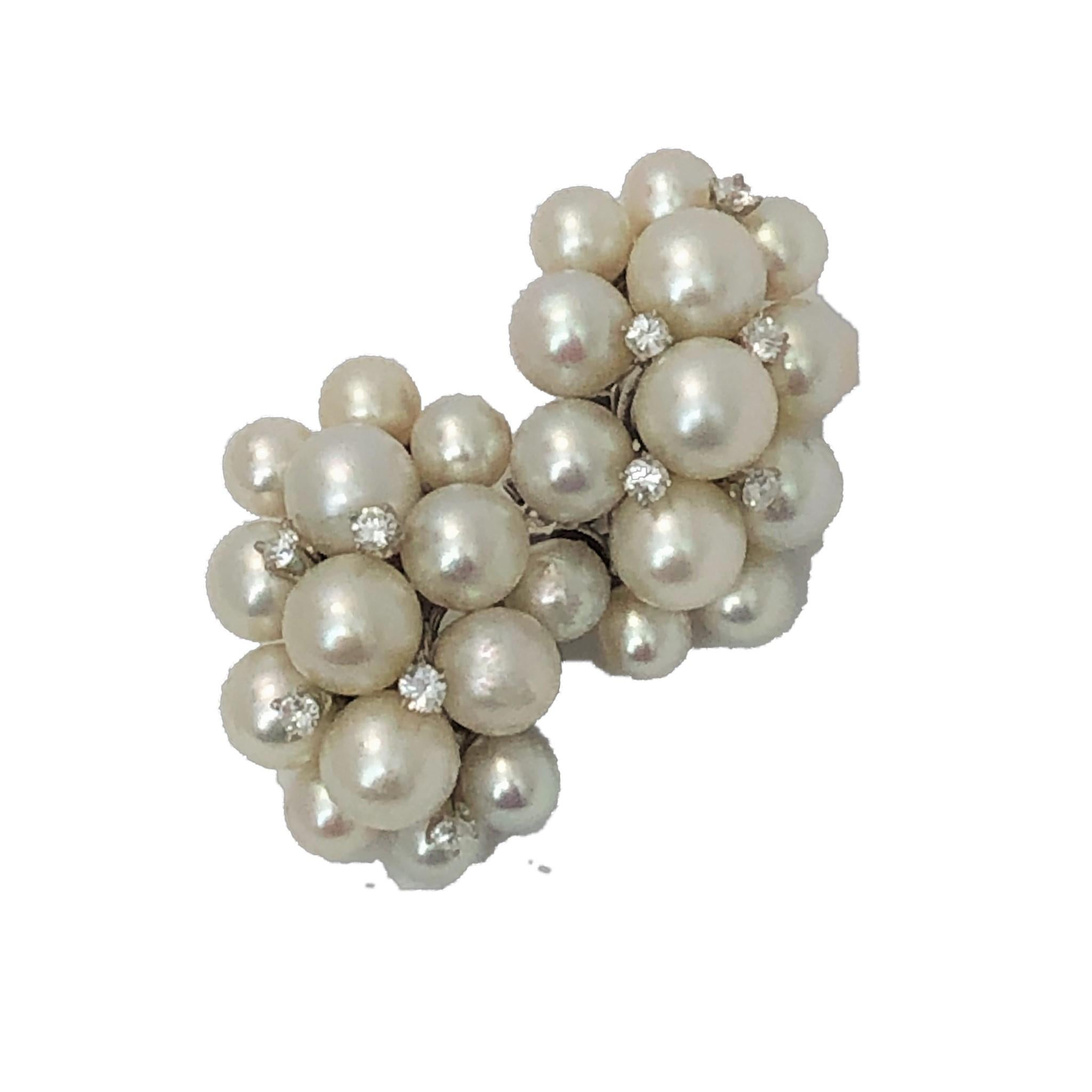 Made by Seaman Schepps sometime in the 1950s-1960s, these elegant, bombee pearl earrings were made in 14K White Gold and are interspersed with 10 round brilliant cut diamonds weighing an approximate total of .50CT of overall G/H Color and VS1