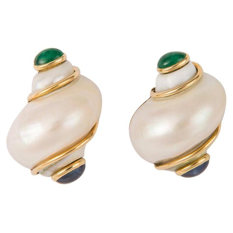 Vintage Seaman Schepps Turbo Shell Emerald Sapphire Cabochon Gold Earring Mother of Pearl
This exquisite pair of earrings are beautifully crafted in platinum and they are clip earrings. Post can be added .
Clip on earrings
Weight of the earring 19