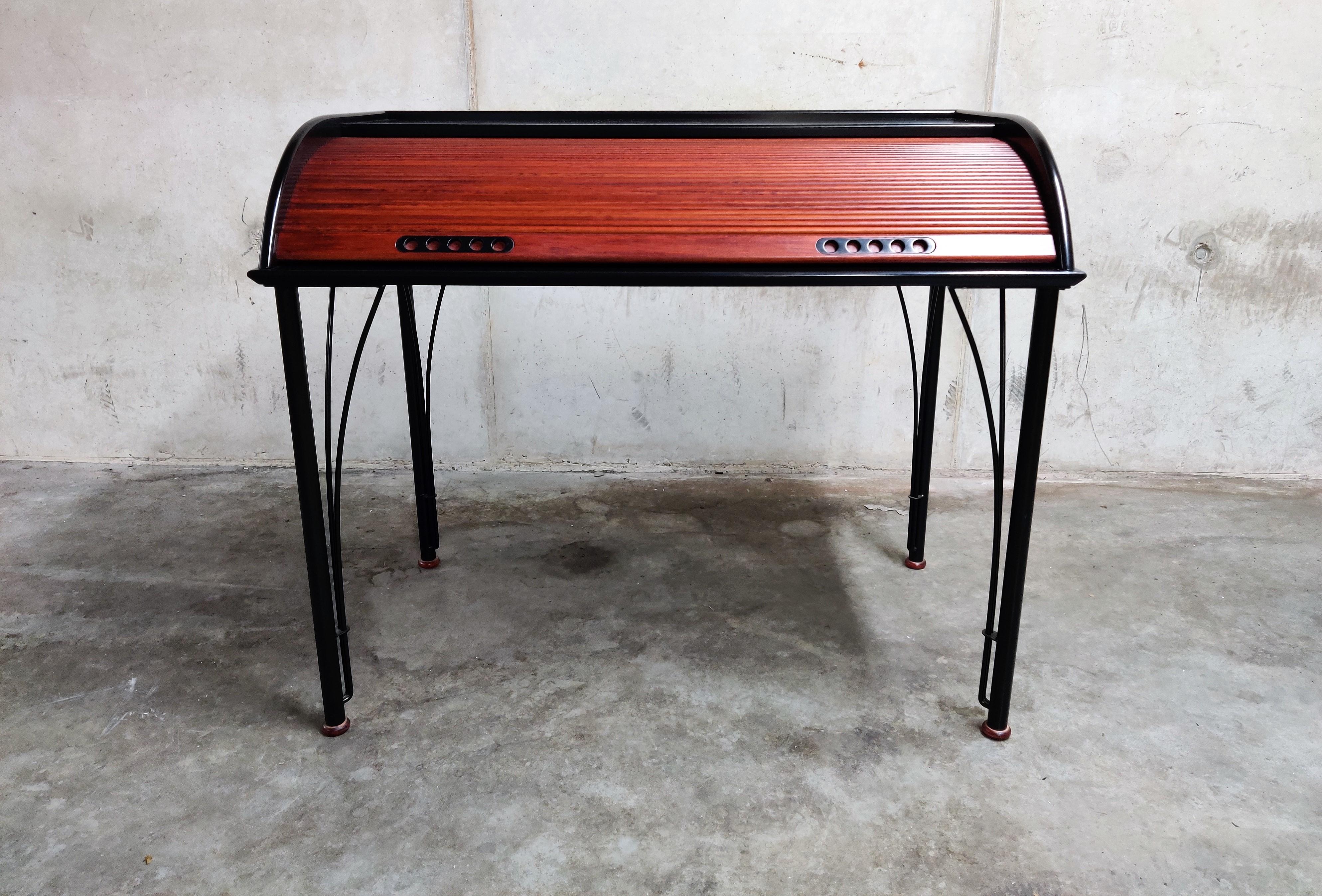 Elegant secretary desk by Pagnon Patrick & Pelhaitre Claude designed in 1988 for Ligne Roset.

This rare and unique desk is made of high quality materials with steel legs, lacquered wood and mahogany roll-up 'door'.

The original and labeled