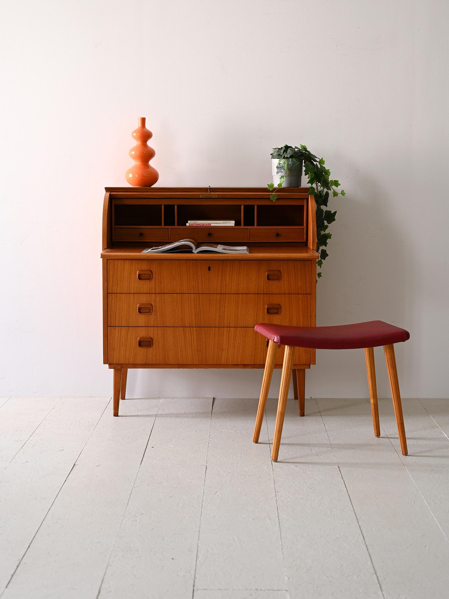 Scandinavian chest of drawers with flap and writing desk.

Timeless elegance for this masterfully crafted 1960s cabinet that combines minimalist Nordic design with a retro feel. 
Consisting of three drawers, the first of which has a lock, it is