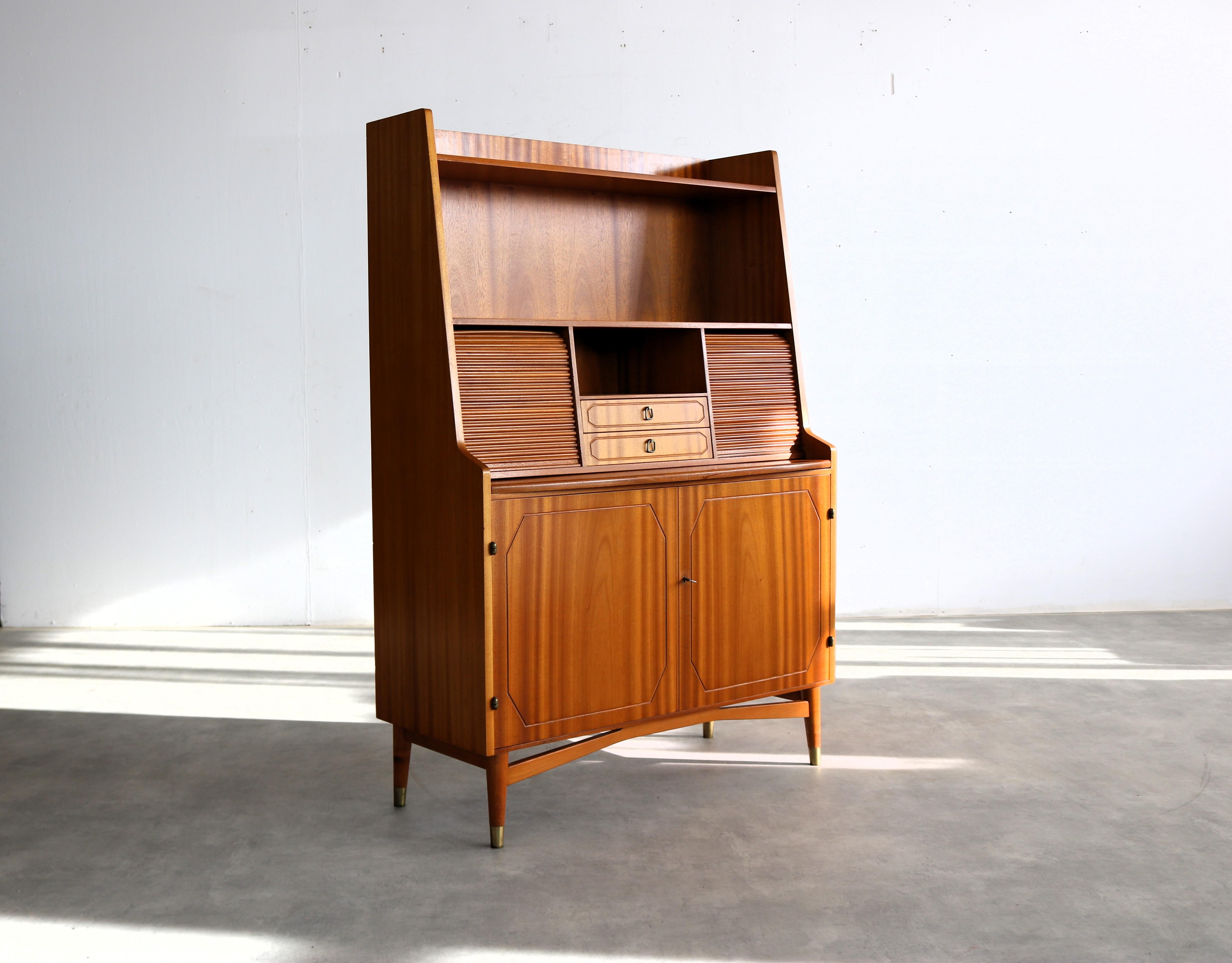 vintage secretary  cupboard  1950s  Blomstermala

period  1950s
design  Blomstermalá  Sweden
condition  good  light signs of use
size  149 x 103 x 42 (hxwxd)

details  teak; brass; tambour doors; extendable work surface;

article number  2569