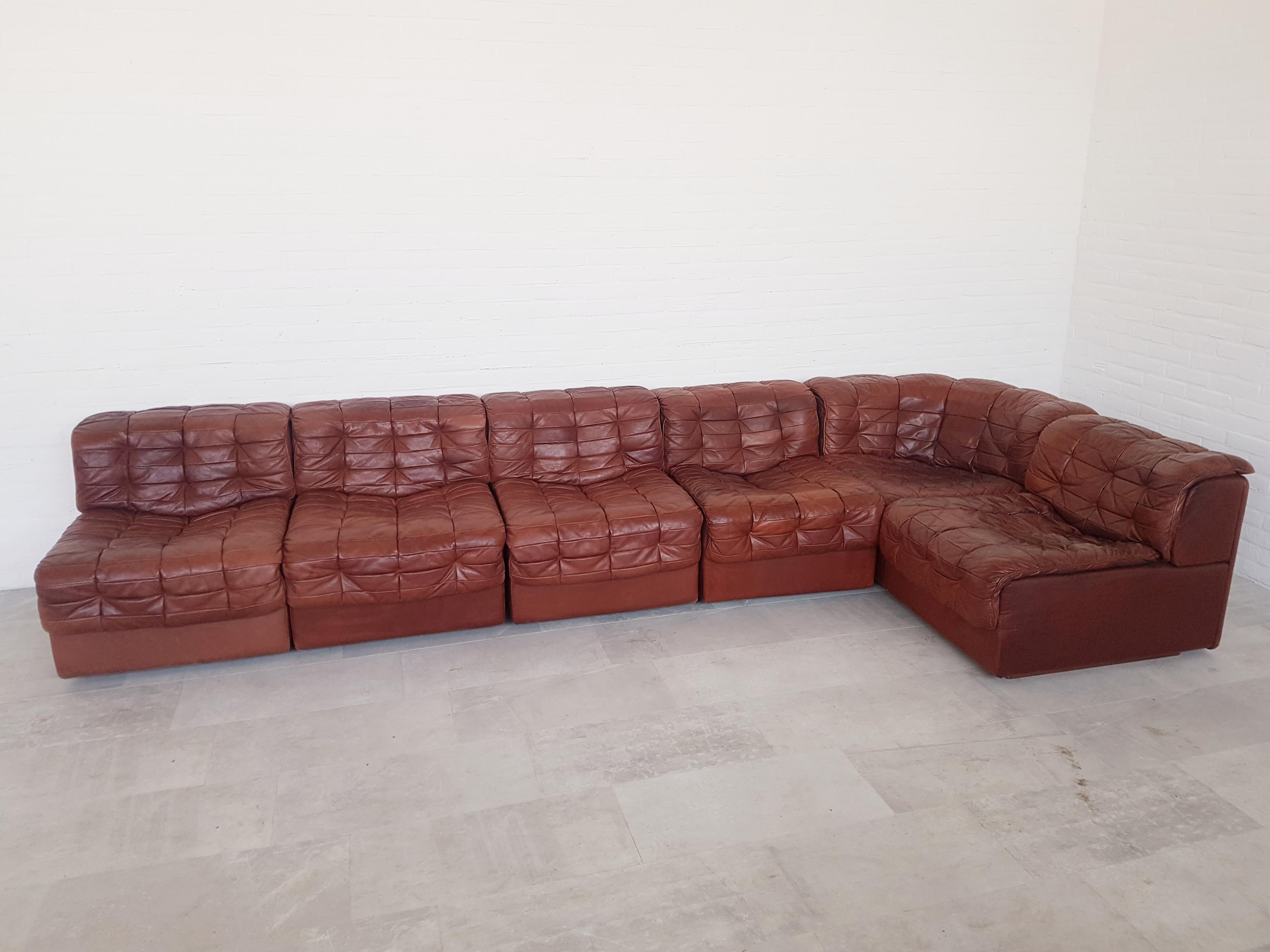 De Sede Switzerland, the world's leading manufacturer of luxury leather seating, made this modular sectional sofa in the 1970s.
Whiskey or terracotta colored patchwork leather upholstery in great original patina.
Mid-Century Modern piece that