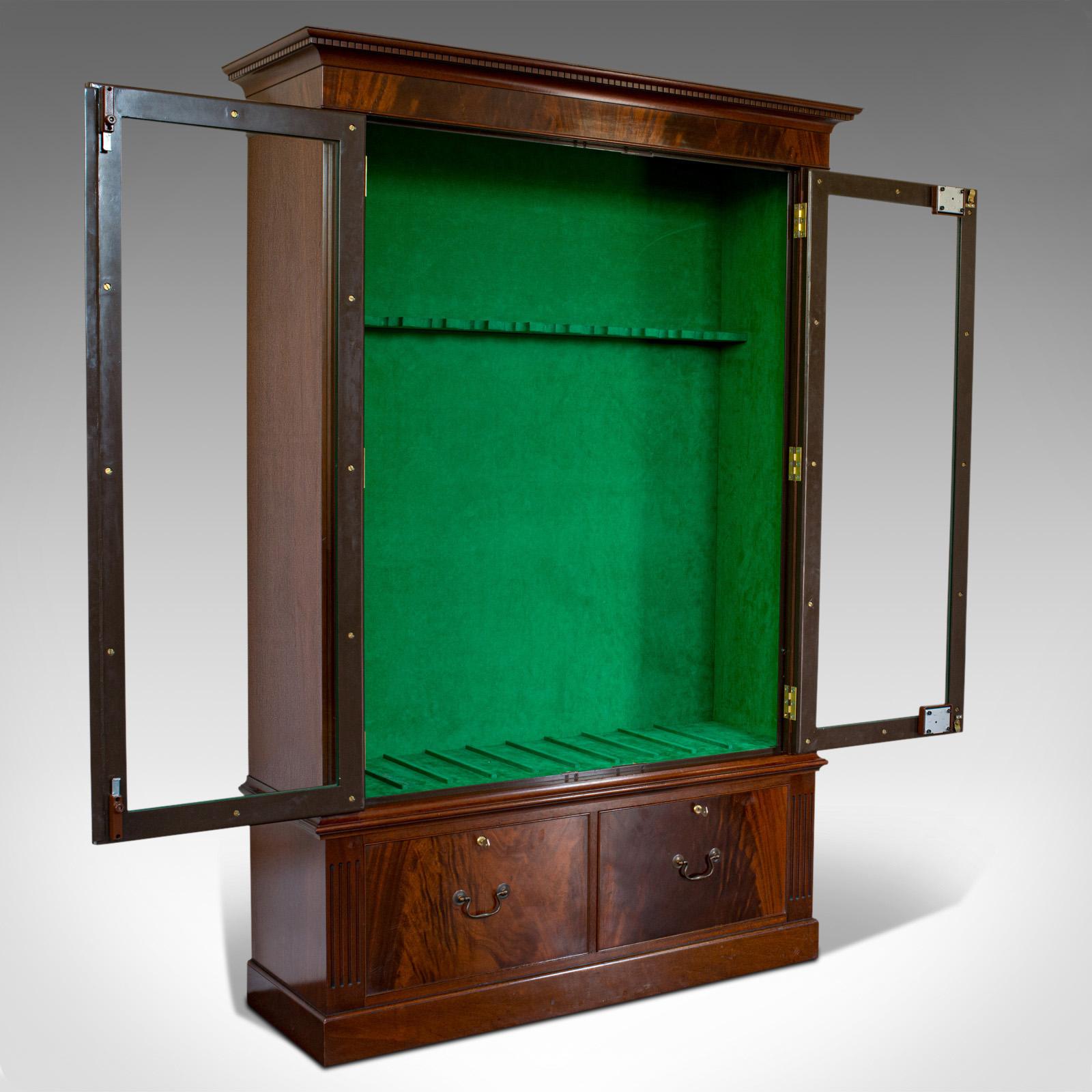 This is a vintage secure display cabinet. An English, mahogany stronghold gun rack, by Asprey of London, dating to the late 20th century.

Superior strength, classically inspired showcase
Displays a desirable aged patina
Select mahogany shows
