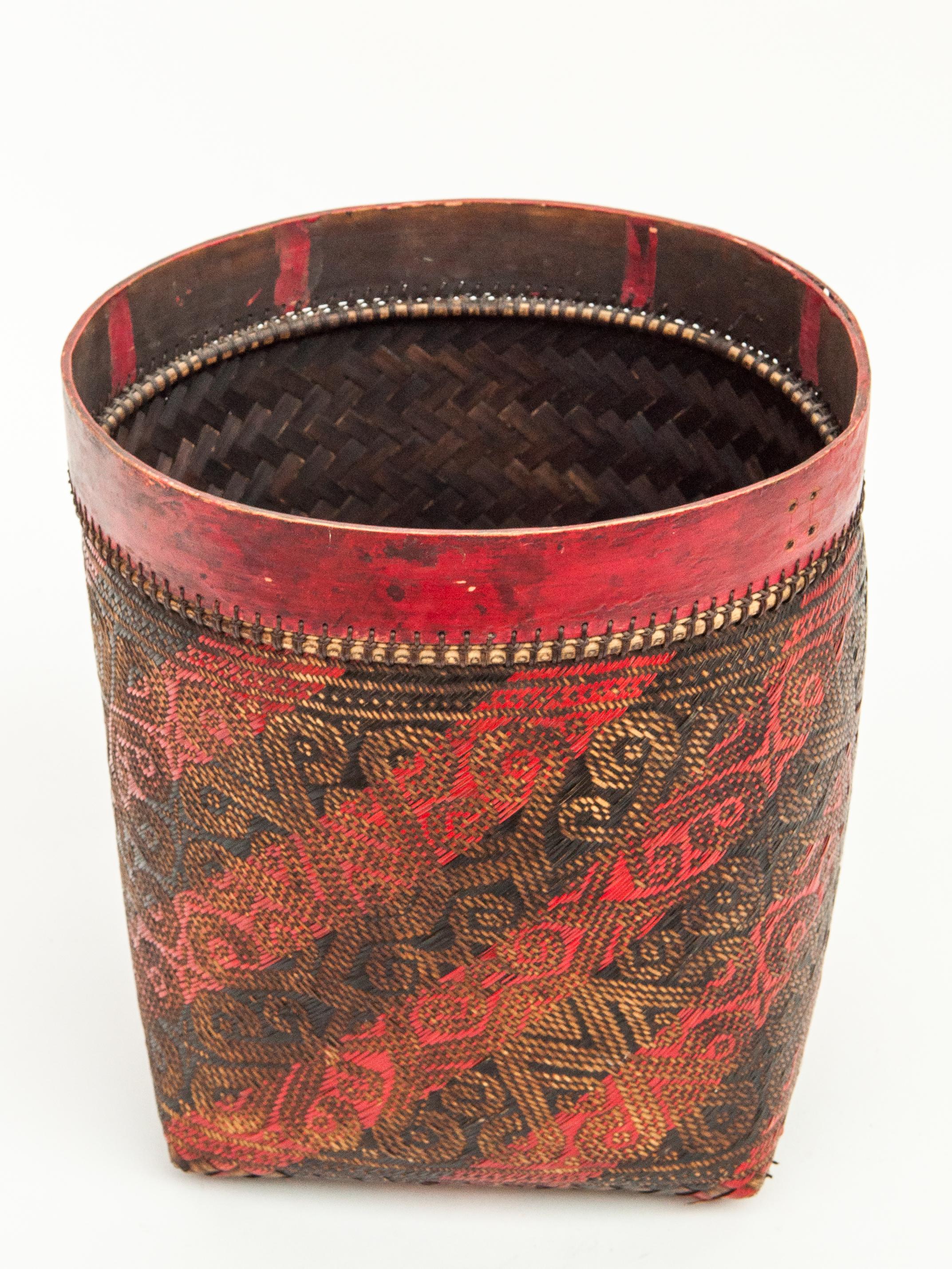 Vintage seed basket. With woven design, Iban of Borneo, mid-late 20th century.
Offered by Bruce Hughes.
This finely woven basket is double woven of bamboo and rattan in stripes of red and black, and incorporates vegetative fertility motifs in a