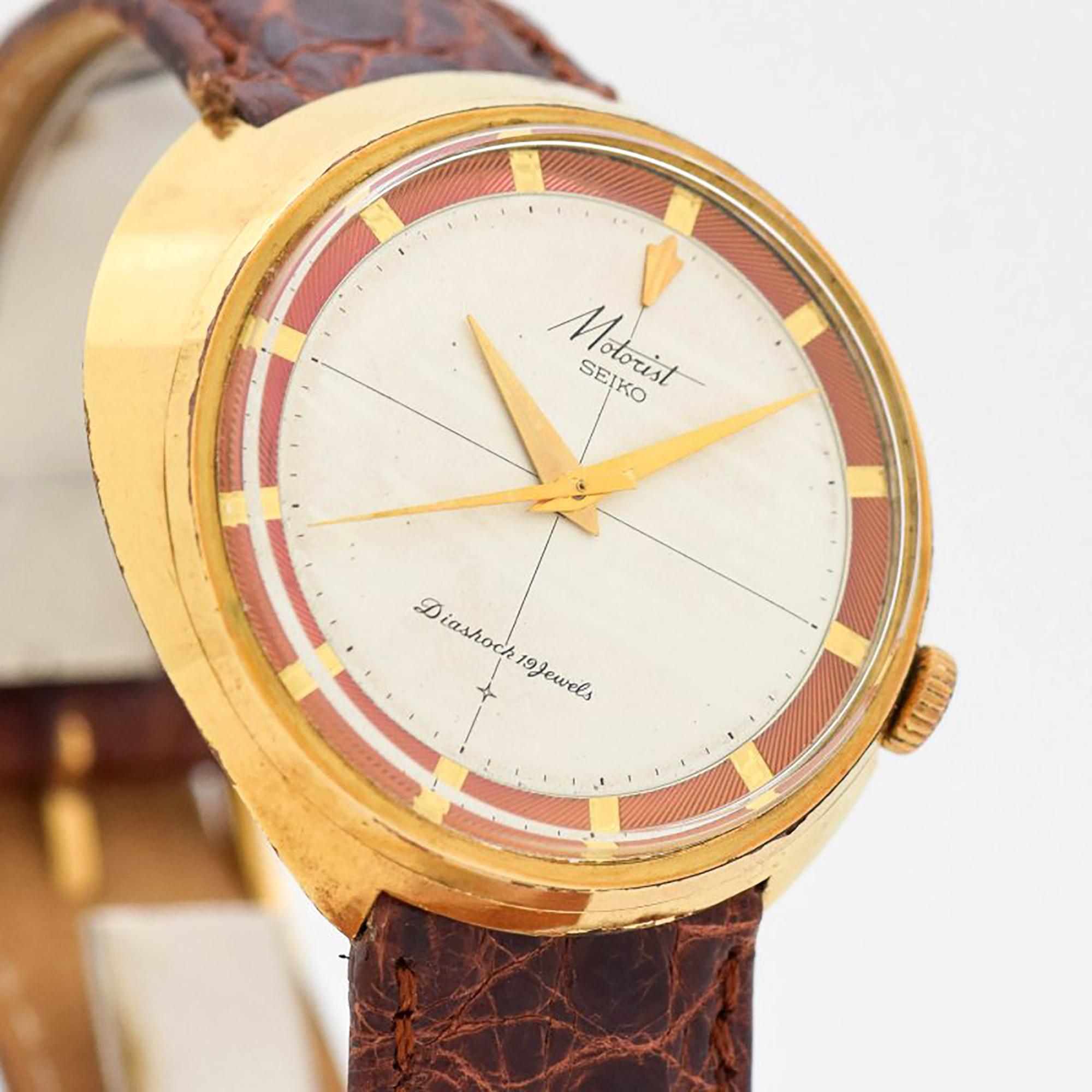 1960's Vintage Seiko Motorist Diashock Driver's Unique Wedge Shape Design Yellow Gold Plated with Stainless Steel Case Back watch with Original Two Tone Silver and Salmon color Dial with Recessed Stick/Bar/Baton Markers. 38mm x 38mm lug to lug (1.5