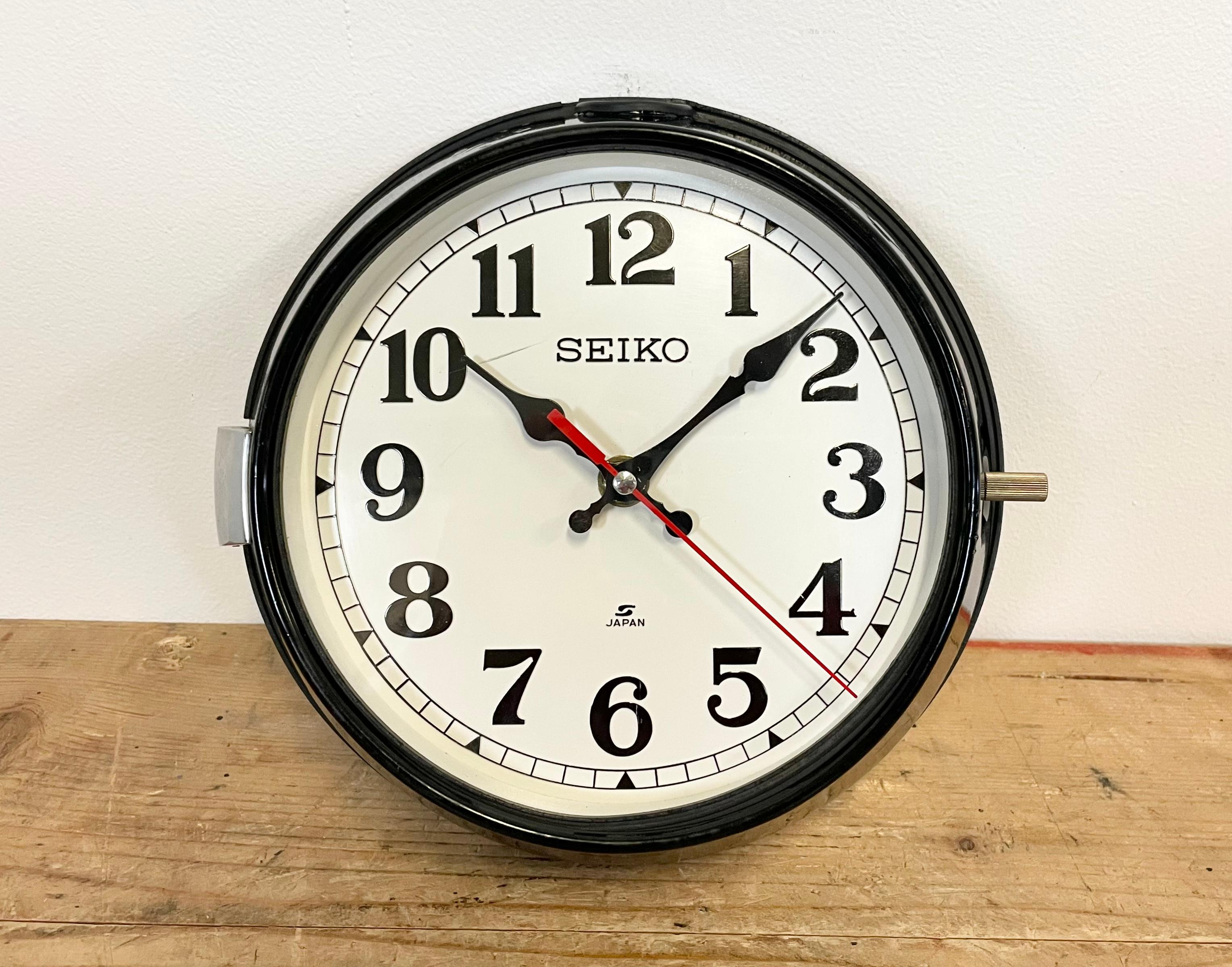 Vintage Seiko navy slave clock designed during the 1970s. These clocks were used on large Japanese cargo ships. It features a black metal frame, a white plastic dial and clear glass cover. This item has been converted into a battery-powered