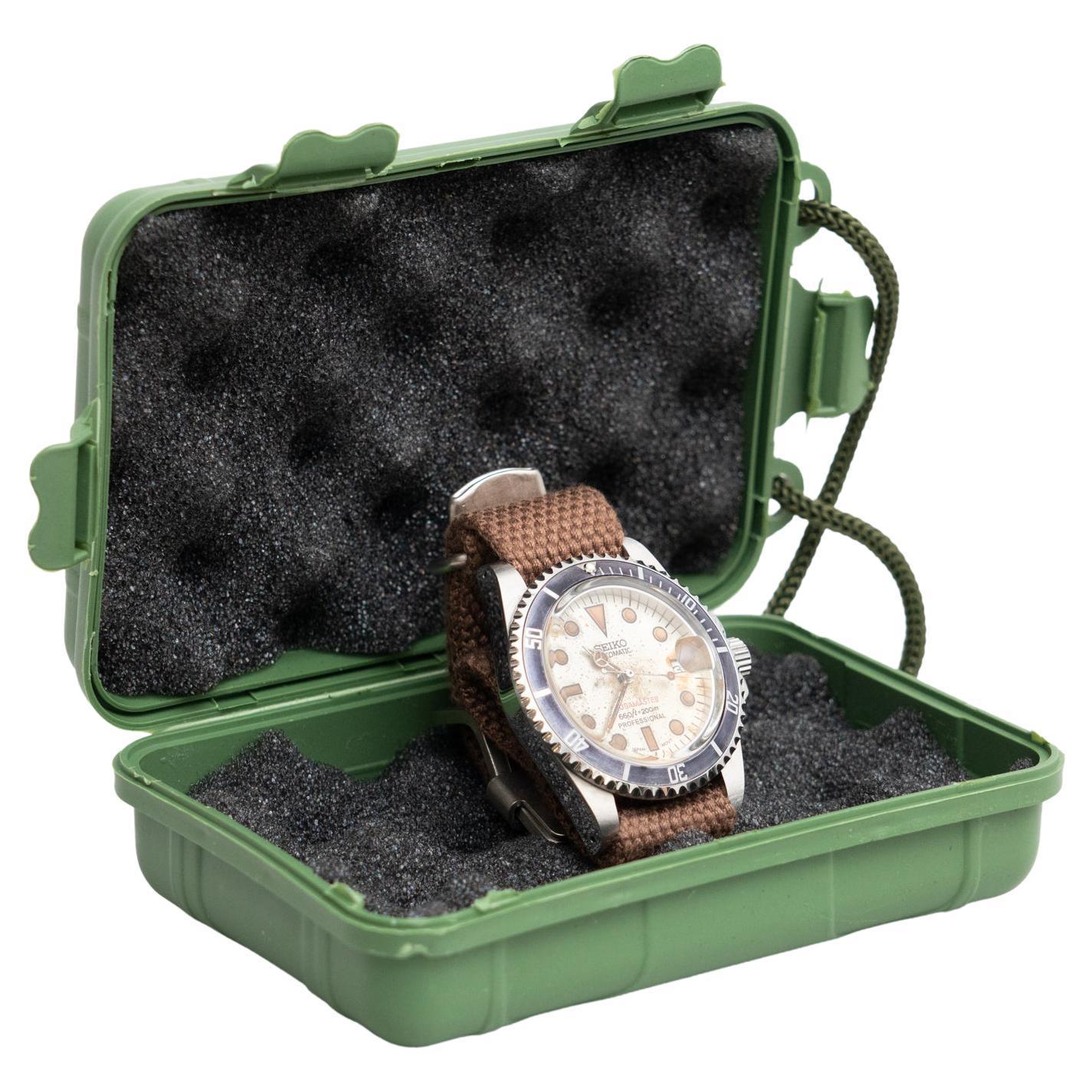 Vintage Seiko wristwatch manufactured and restored by an unknown artisan.  In original condition, wear consistent with age and use, preserving a beautiful patina.  Materials: Metal Fabric 
