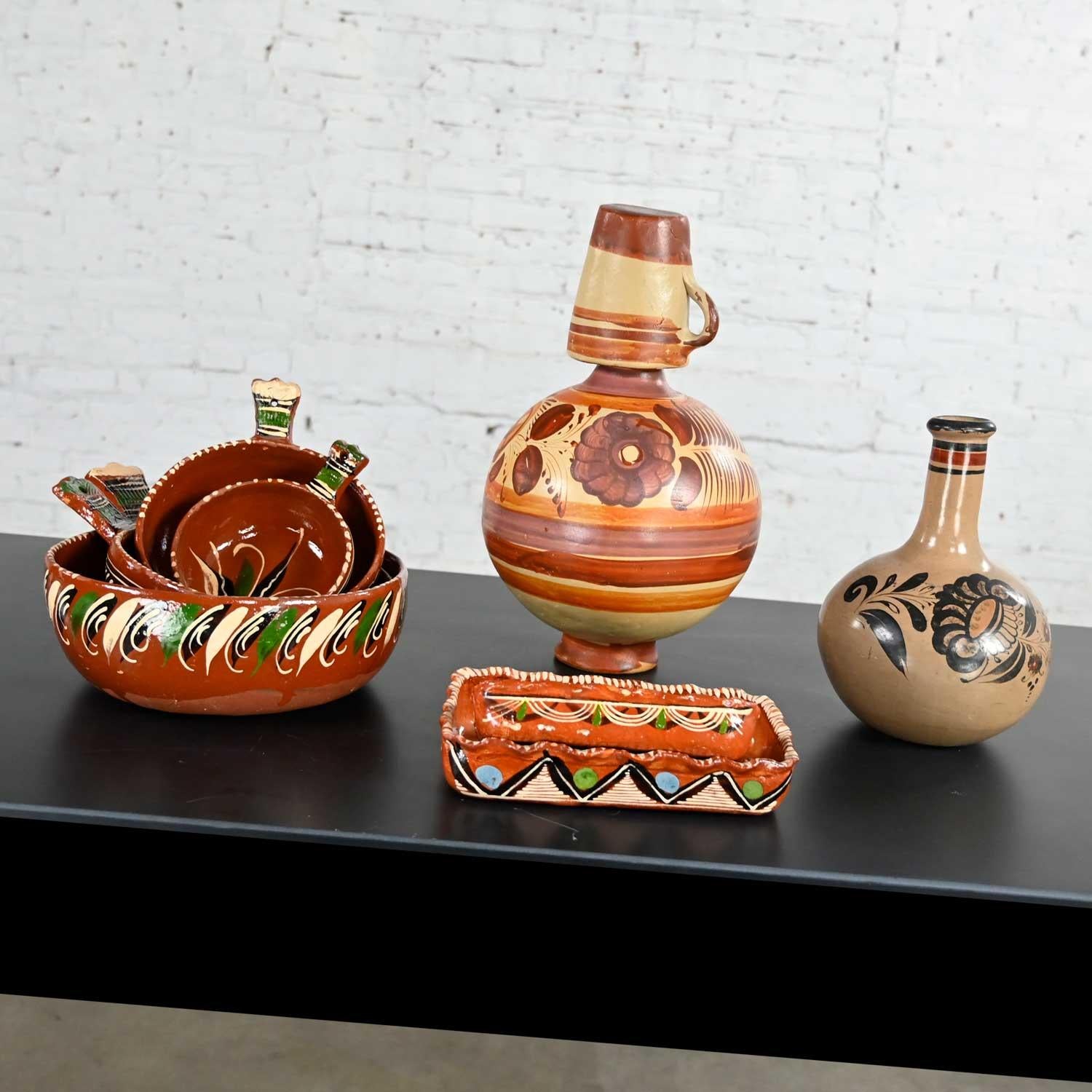 Fabulous selection of vintage Mexican pottery including four nesting bowls with handles, two nesting baking dishes, one carafe & cup, and one bottle or vase. Beautiful condition, keeping in mind that these are vintage and not new so will have signs