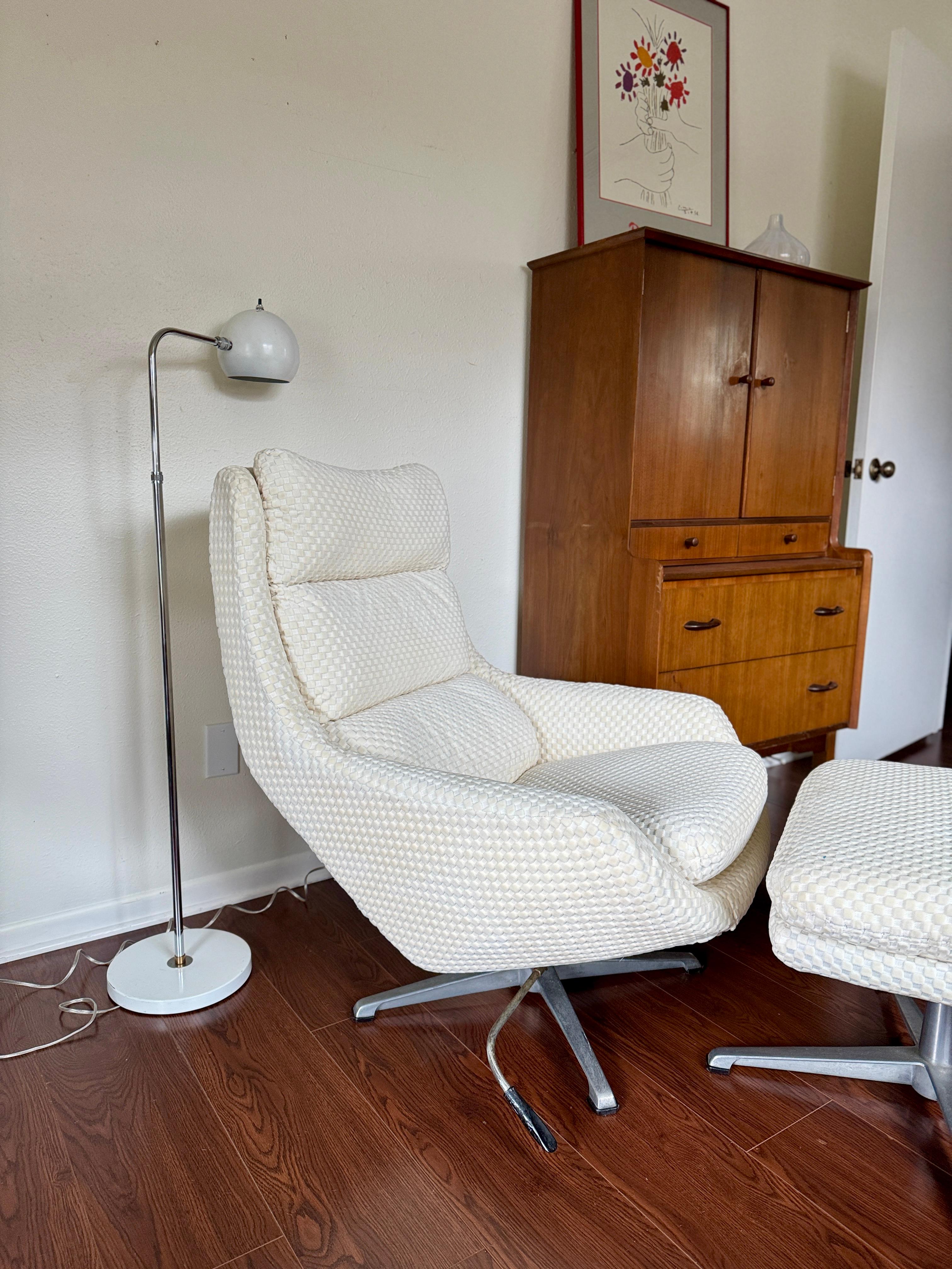 Vintage Selig Swedish modern swivel recliner lounge chair with ottoman, circa 1970s. Made in Sweden by Overman AB for Selig, this sculptural set combines sleek Scandinavian design with irresistible comfort. The chair features a wide, cushioned seat,