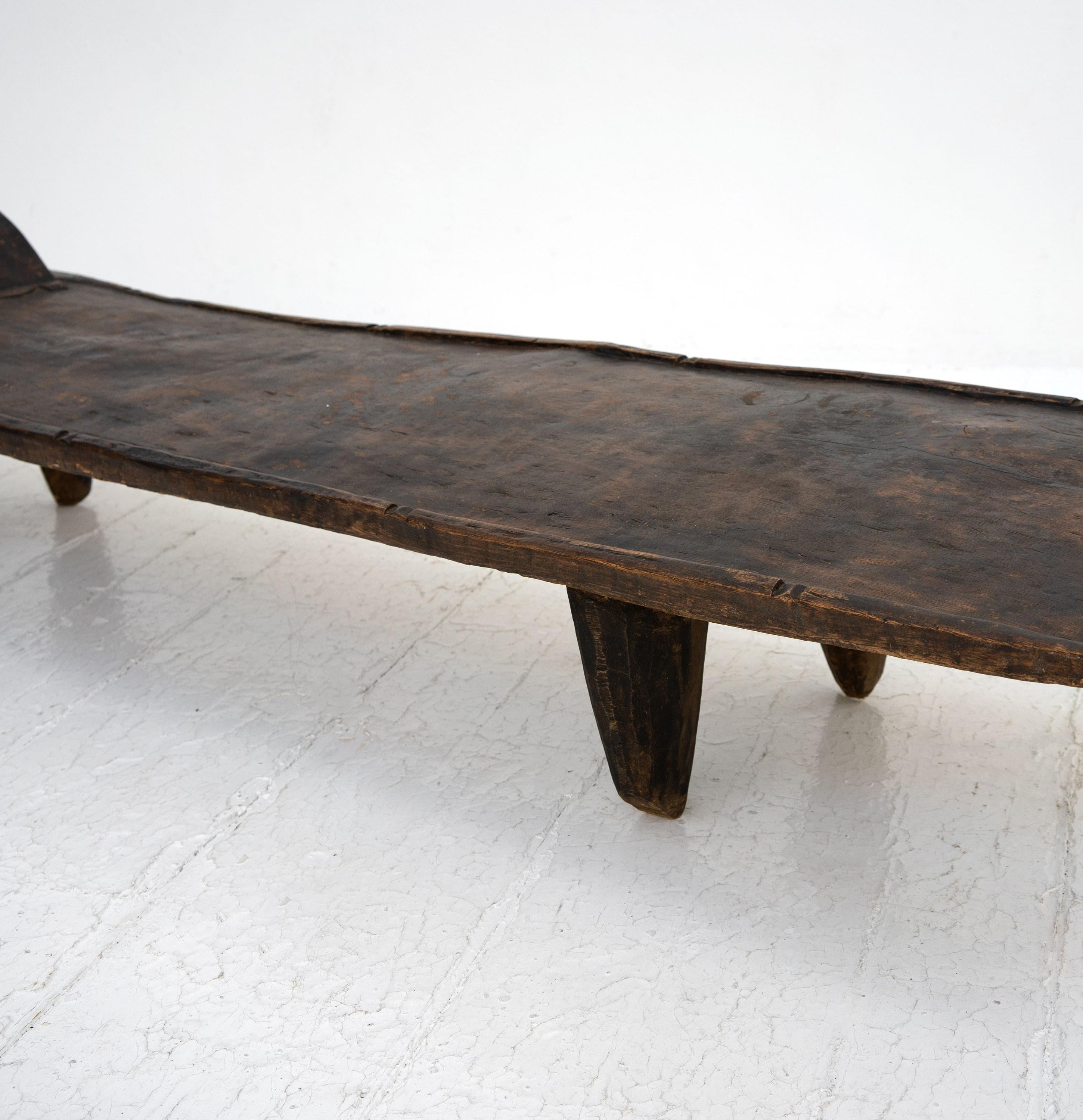 A 20th Century Senufo birthing table carved from one piece of African hardwood by the Senufo people of Côte d'Ivoire, West Africa.

Dimensions (cm, approx):
Height: 27
Width: 203
Depth: 42
