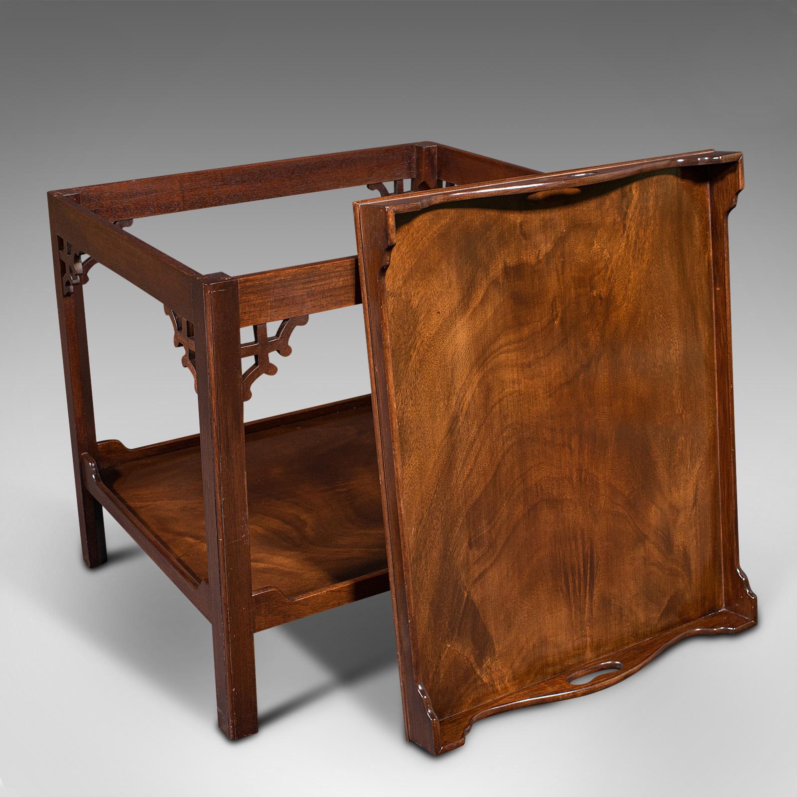 This is a quality vintage serving tray table. An English, mahogany afternoon tea or drink's stand in the Chippendale manner, dating to the late 20th century, circa 1970.

Appreciable late 20th century quality with Chippendale influence
Displays a