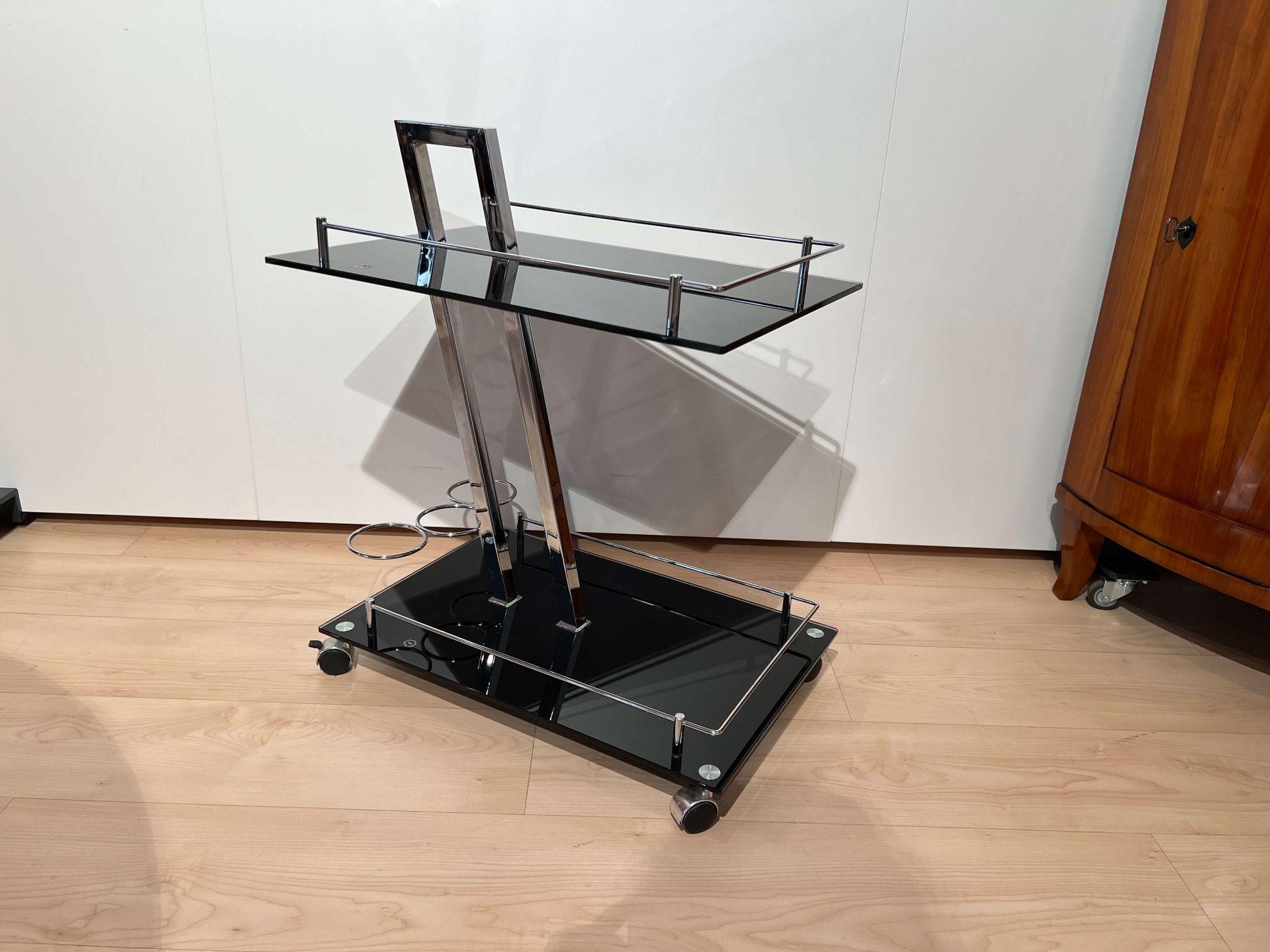 Vintage italian Serving Trolley or Bar Cart, black glass and chrome from the 1970s.
 
Black safety glass shelves. 
Chrome plated high quality metal frame. 
 
Dimensions: 
H 72 cm x W 60 cm x D 40 cm
H 28.34