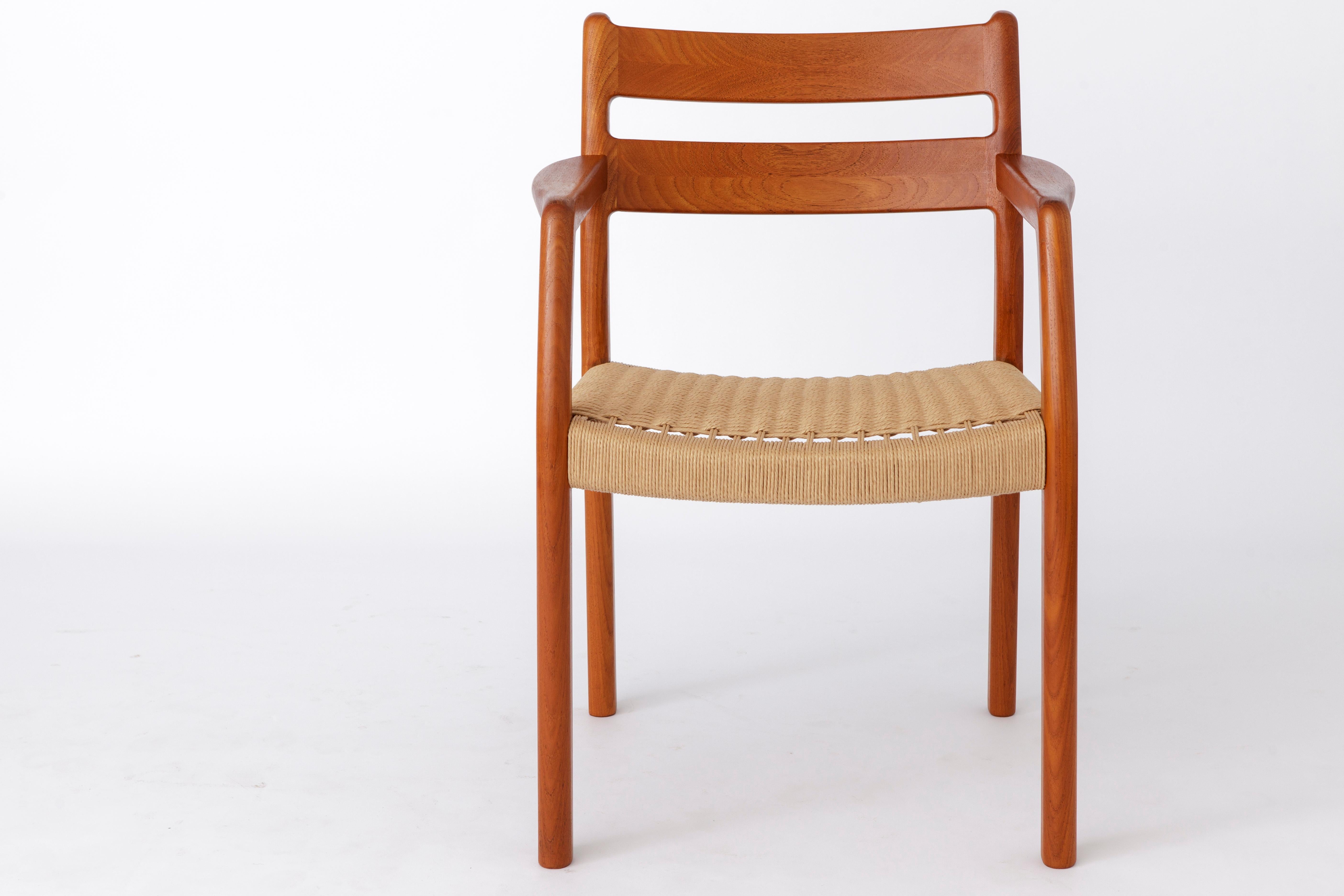 Teak mid-century armchair by Danish manufacturer EMC Mobler. 
Production period: 1960s. 

Good, stable condition. Massive teak wood. 
Very sturdy. Wood surface was refurbished and oiled. 
Seat weaving was renewed. 
Goes well with the other 4 or 6