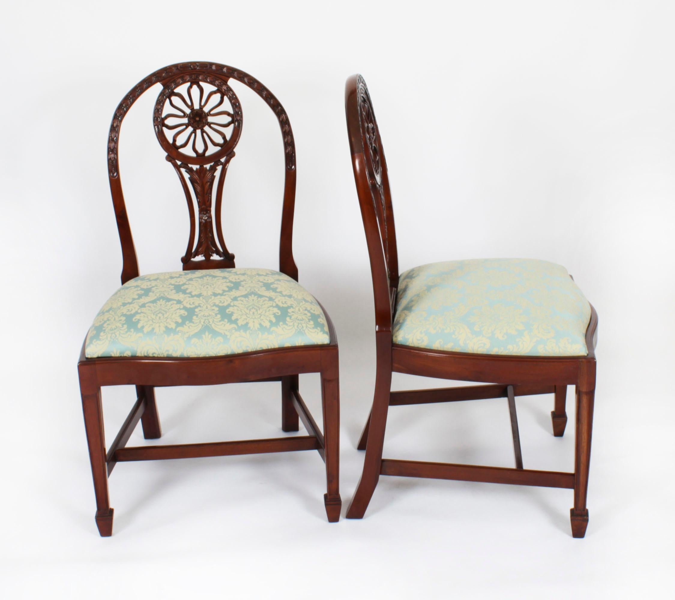 This is a fantastic Vintage English set of ten Hepplewhite Revival mahogany dining chairs, mid 20th century in date..

The set comprising ten side chairs, the oval backs with shaped and pierced sun rondal and feature beautiful hand carved bow and