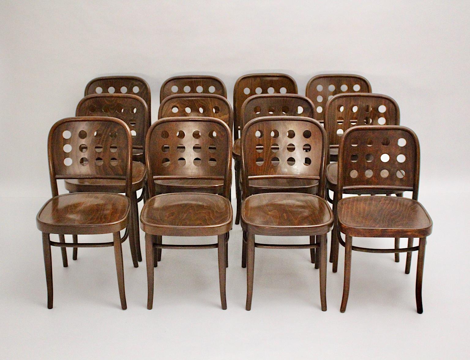 Josef Hoffmann style 12 vintage dining chairs from beech bentwood in chocolate brown color tone 1990s in an amazing shape.
While the backrest features 12 holes for an interesting form, the seat invites with for a comfortable seating.
The dining