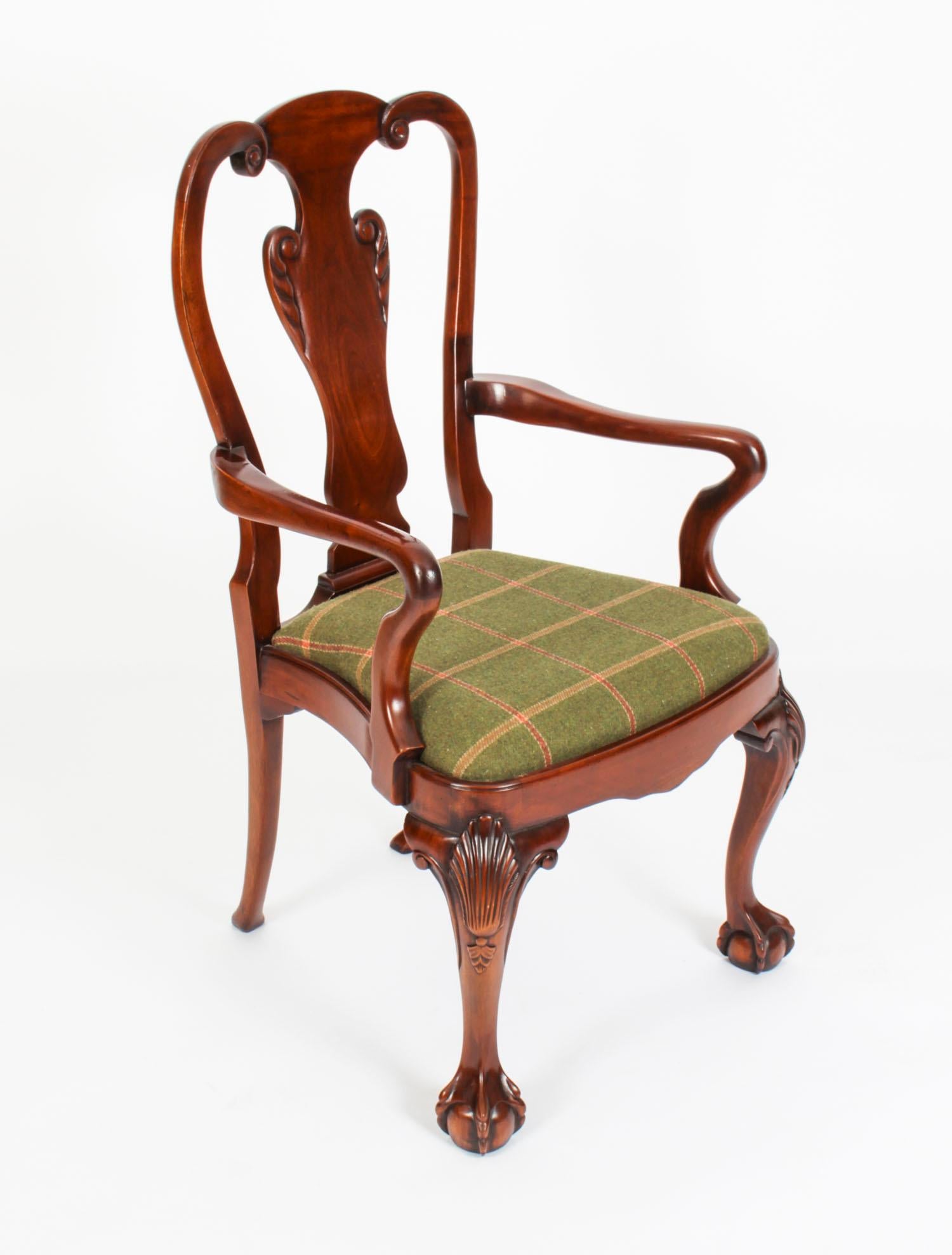 An absolutely fantastic set of twelve vintage Queen Anne Revival dining chairs, dating from the mid 20th century.

The set comprises ten side chairs and a pair of armchairs. They have been masterfully crafted in beautiful solid mahogany and the