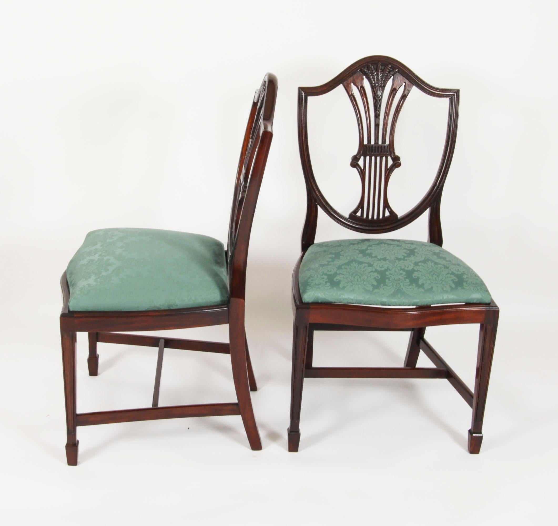The fantastic vintage set of fourteen wheatsheaf shieldback mahogany dining chairs, date from the mid 20th Century.

Masterfully crafted in beautiful solid mahogany throughout, the finish and attention to detail on display are truly