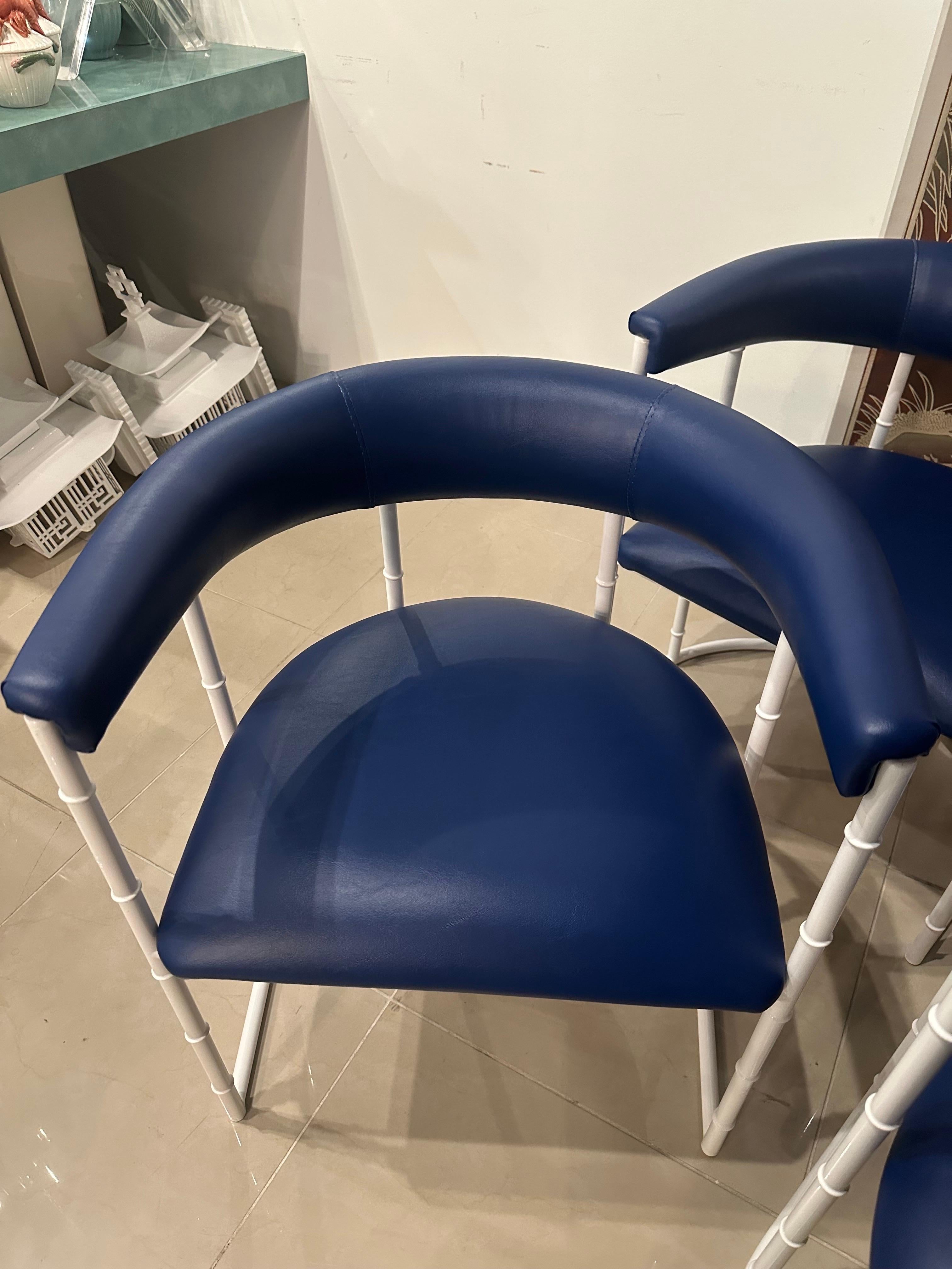 Set of 4 vintage faux bamboo metal barrel curved arm dining chairs. Patio, outdoor, porch, pool. These have been newly powder-coated in a crisp white. All new cushions including insides and seat strapping underneath. Done in a navy blue Sunbrella