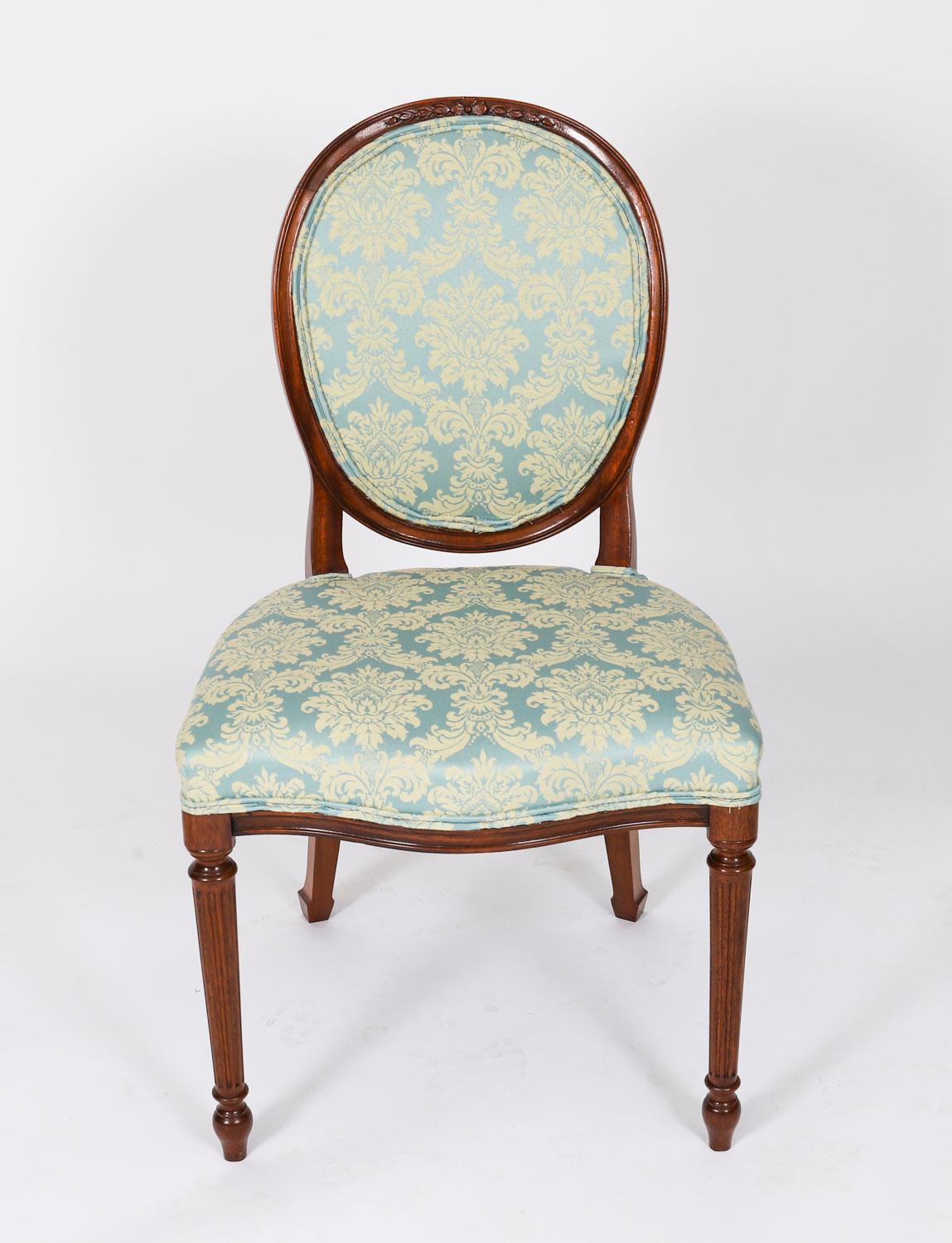 This is a fantastic English made vintage set of eight Louis XIV Revival upholstered back dining chairs, mid-20th Century in date.
 
These chairs have been masterfully crafted in beautiful solid mahogany and have been reupholstered in the finest