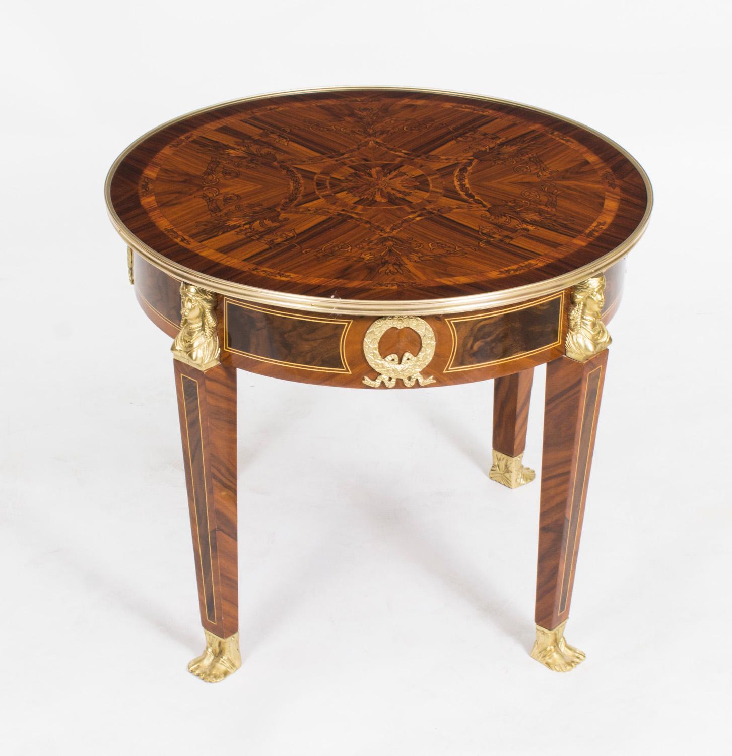 This is a stunning set of three vintage Empire Revival ormolu mounted burr walnut and marquetry inlaid tables comprising a pair of side tables and a coffee table.

They have stunning ormolu decoration with laurel leaves, female caryatids lion's