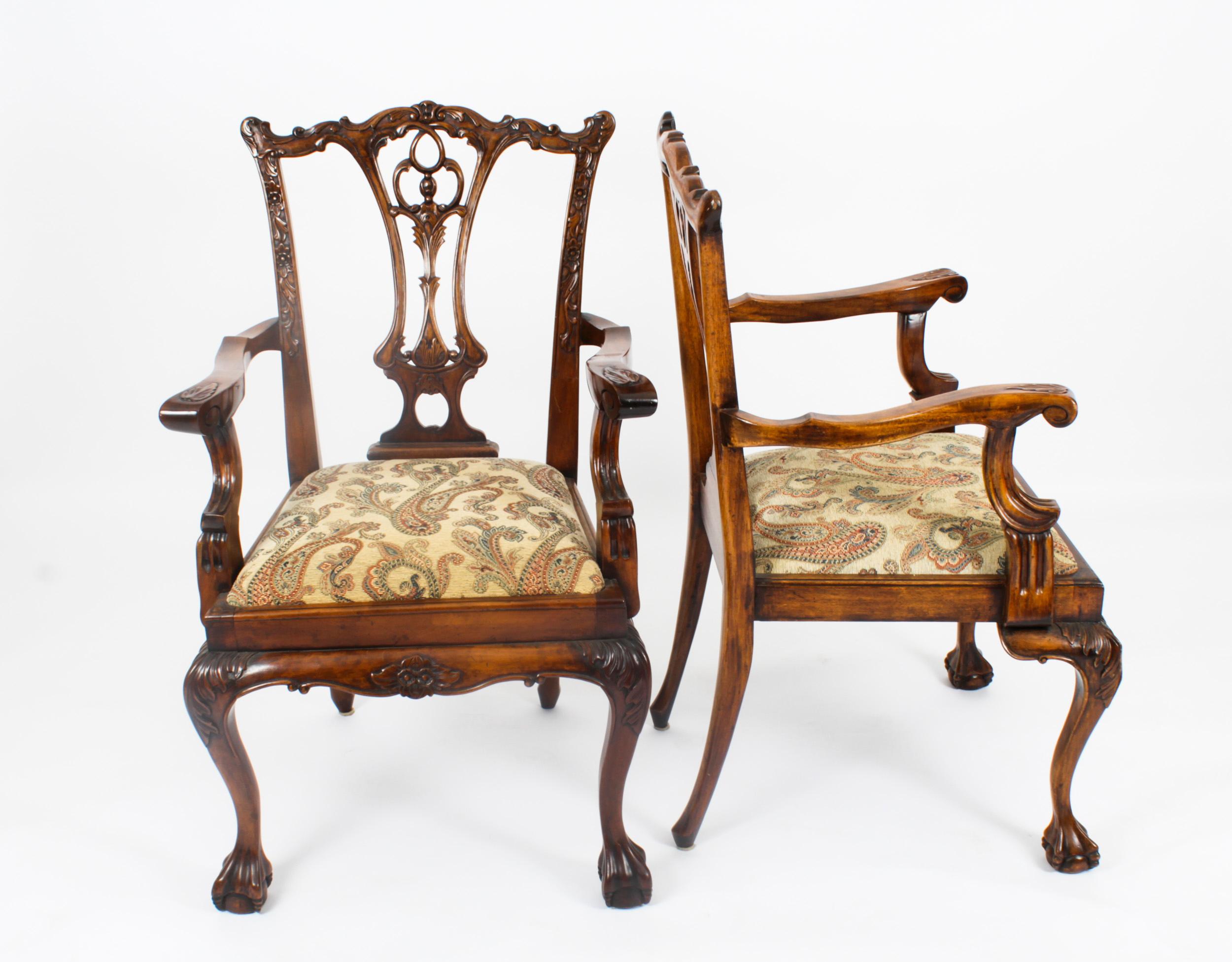 A beautiful Vintage set of ten solid mahogany Chippendale Revival dining chairs, comprising eight sidechairs and two armchairs, dating from the mid 20th Century.

They have been crafted from hand carved solid flame mahogany with drop in seats