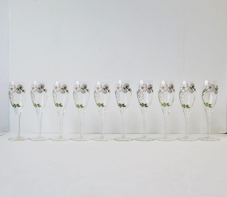 A beautiful set of ten (10) vintage Perrier-Jouet French champagne flute glasses with iconic floral motif in the Art Nouveau style, circa mid to late-20th century, France. Made in France. This iconic floral design of Japanese pink anemone flowers is