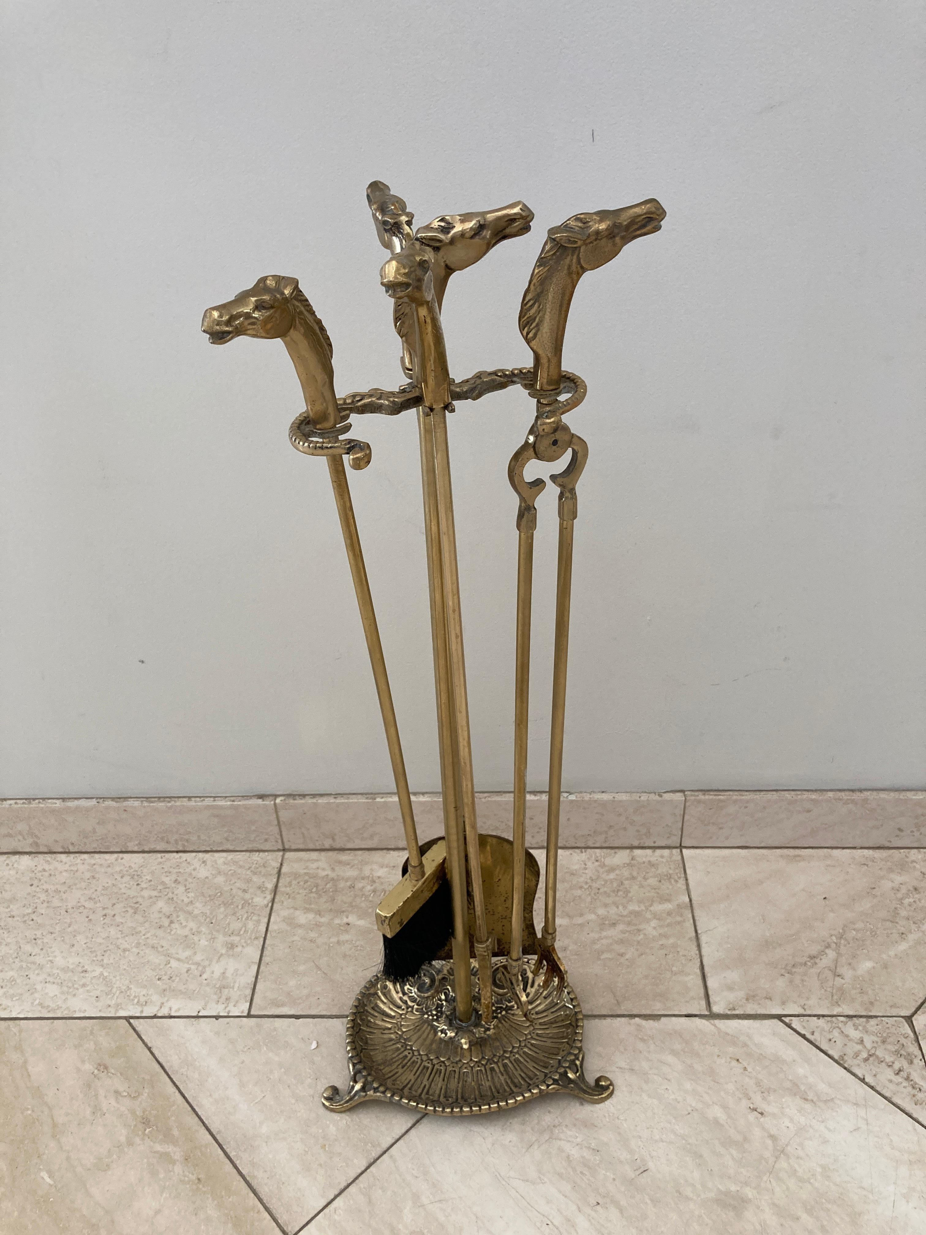 Vintage equestrian horse brass heads fireplace tools.
This set of vintage brass fire tools, includes broom, tongs, shovel and poker on elaborate stand with gallery to the base, each with beautifully detailed horse head motif as handle. 
Great design