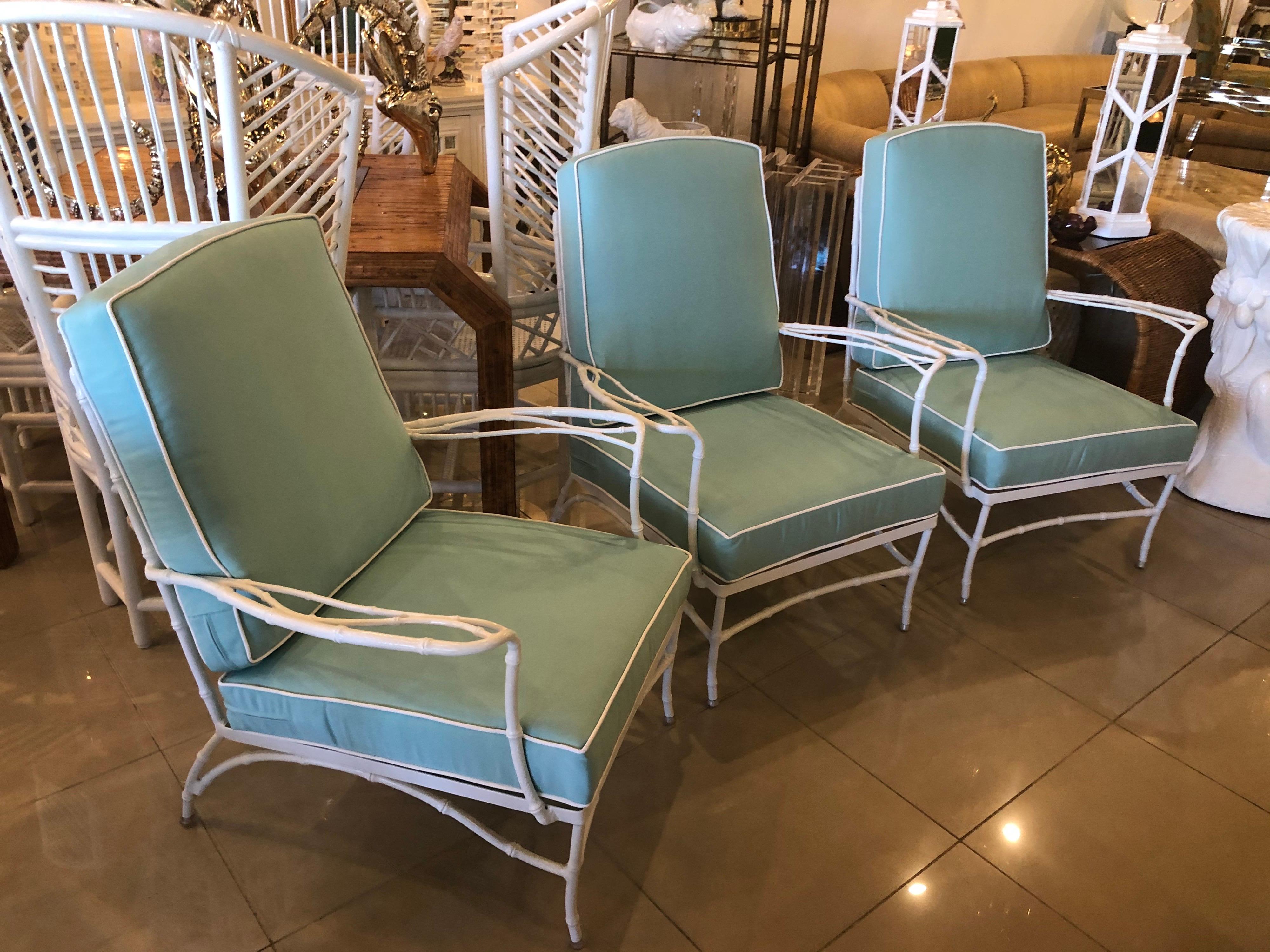Lovely set of 3 vintage metal, faux bamboo arm chairs, club, lounge for patio, outdoors, sunroom. These have been newly powder-coated in a clean white. All new custom cushions with Sunbrella blue fabric and white trim. 
Back of chair height with