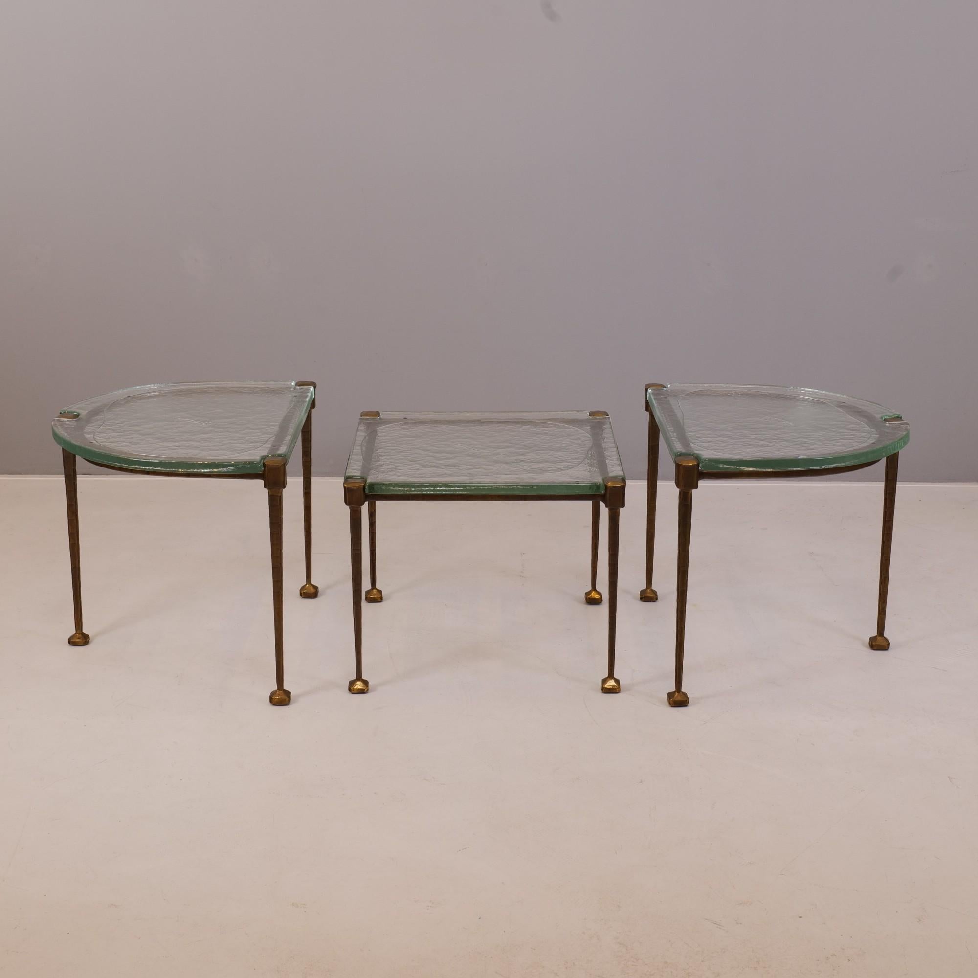 A set of three tables in forged bronze and molten glass. During the melting process of the glass was designed. 

two large tables:
width: 55 cm
depth: 69 cm
heigh: 54 cm

smaller table:
59 cm x 59 cm
heigh: 48 cm