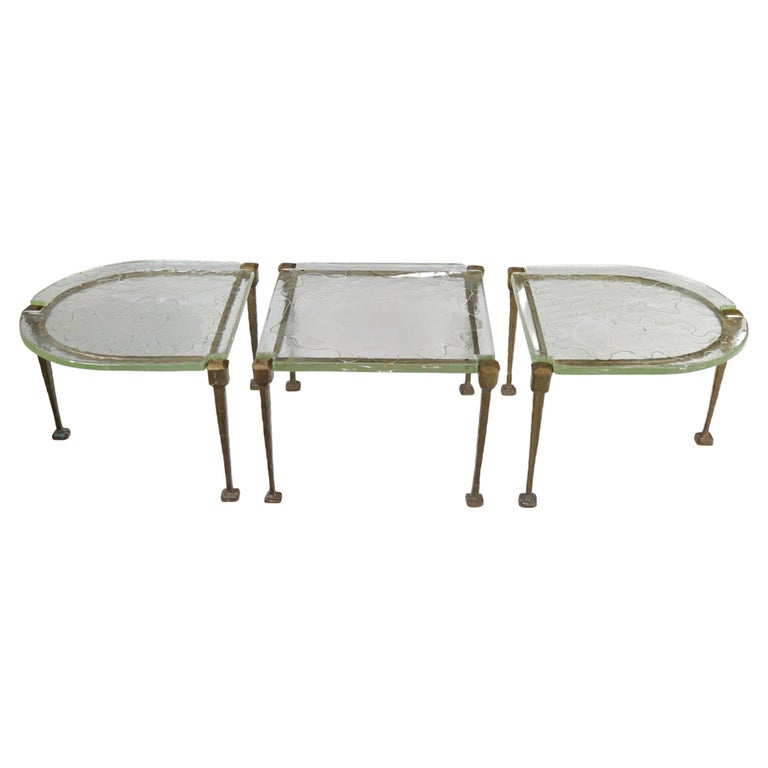 A set of three tables in forged bronze and molten and cut glass. Complicated german manufacturing technique.
3 cm thick glass
Dimensions:
Tables heigh: 48 cm

Middle table:
 66 x 65 cm 
Semicircular tables:
65 cm x 65 cm.




