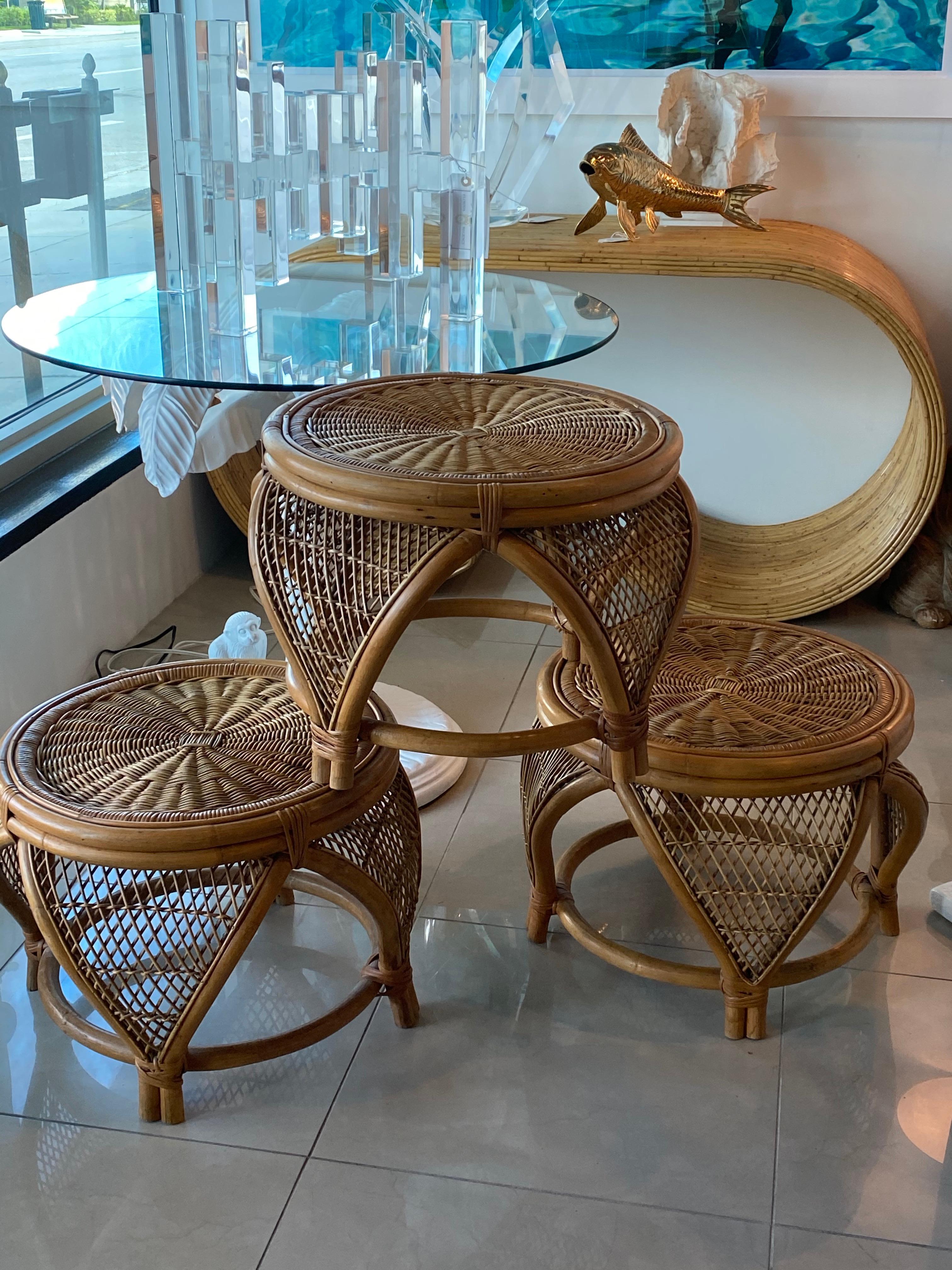 Vintage set of 3 rattan and wicker ottomans, footstools, tables, benches, stools. These could be used in a variety of ways. Beautiful tropical vibe with a Moroccan feel with the flare, arched sides. No damaged or broken wicker. You can add an