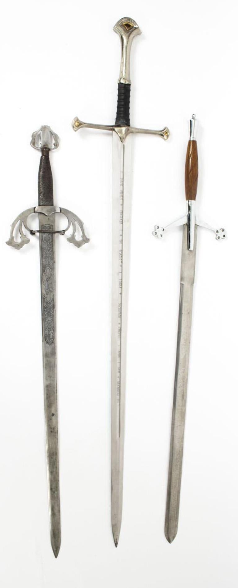 Three superb vintage claymore type two-handed swords, dating from the second half of the 20th Century.

The swords features steel pommels, hilts and decorative cross guards with a double-etched blade, one features a long deep central fuller and
