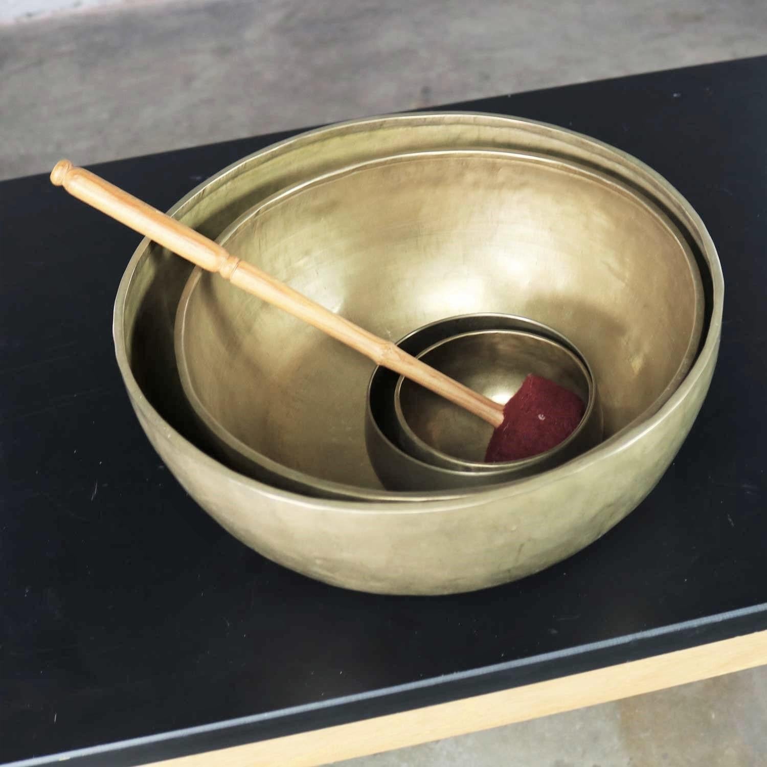 Handsome set of 4 nesting singing bowls or standing bowls with 1 mallet for playing. Handmade of bronze or bell metal with no design. They are in wonderful vintage condition and have awesome patina. You can see the maker’s hand. Please see photos,