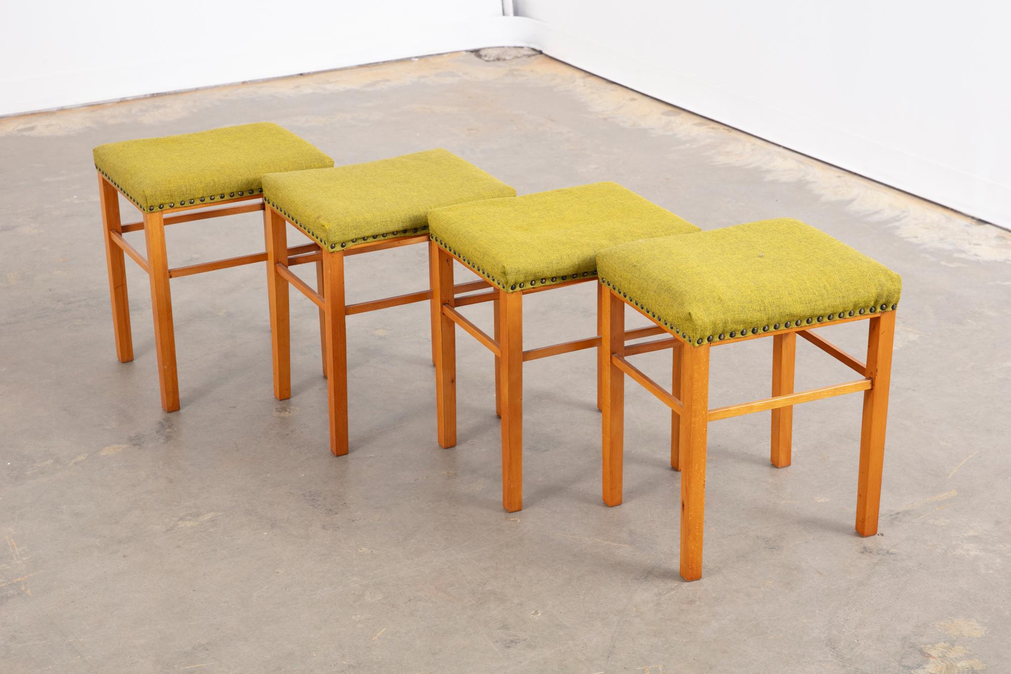 Vintage set of 4 Danish stools with nailhead trim and original green upholstery. Could be used separately or together. 