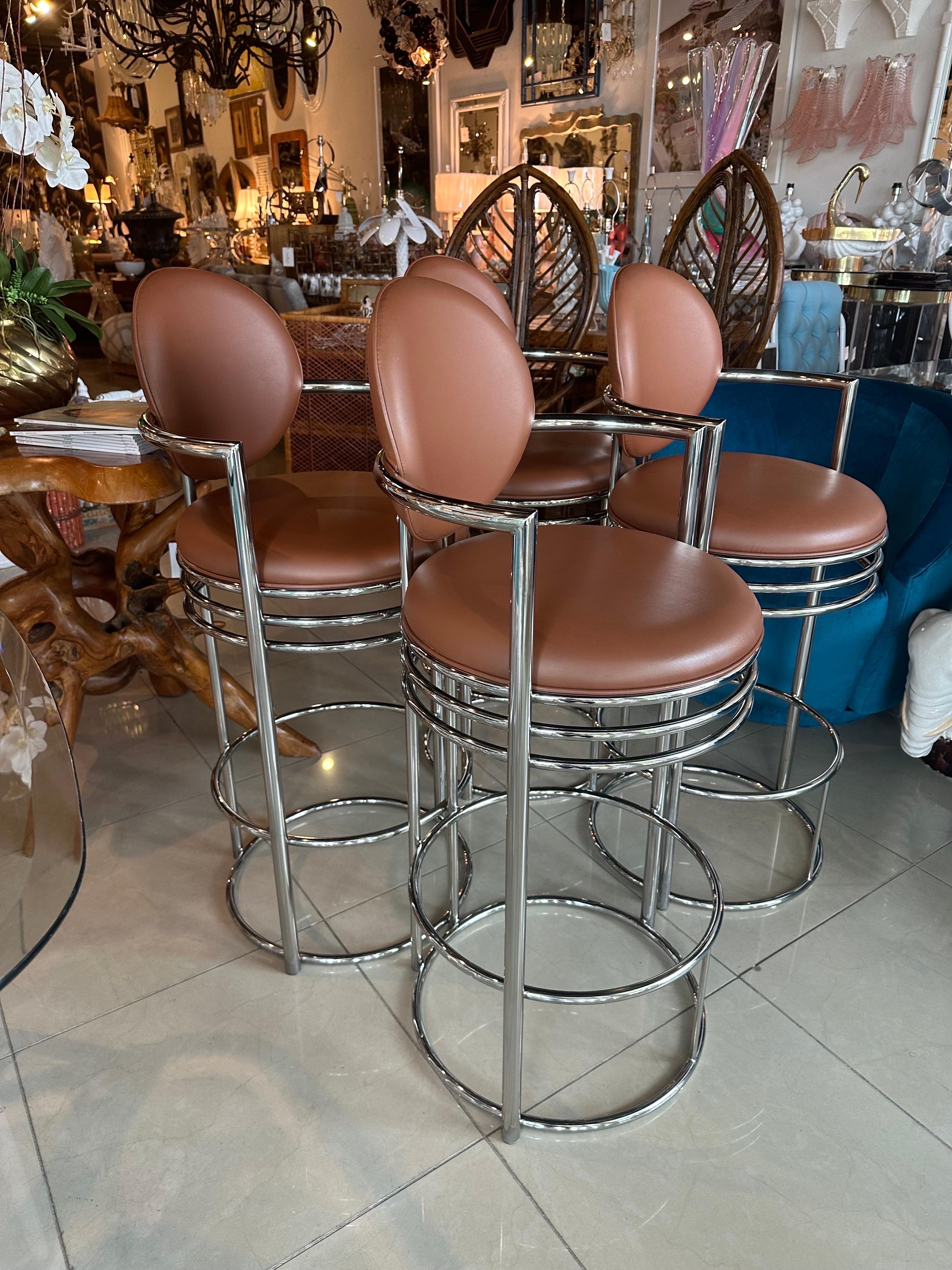 Vintage set of 4 DIA Design Institute of America chrome arm barstools stools, tagged underneath. Chrome has been polished but may have some slight patina. Original vinyl upholstery has a few slight blemishes, impressions. I recommend new upholstery.