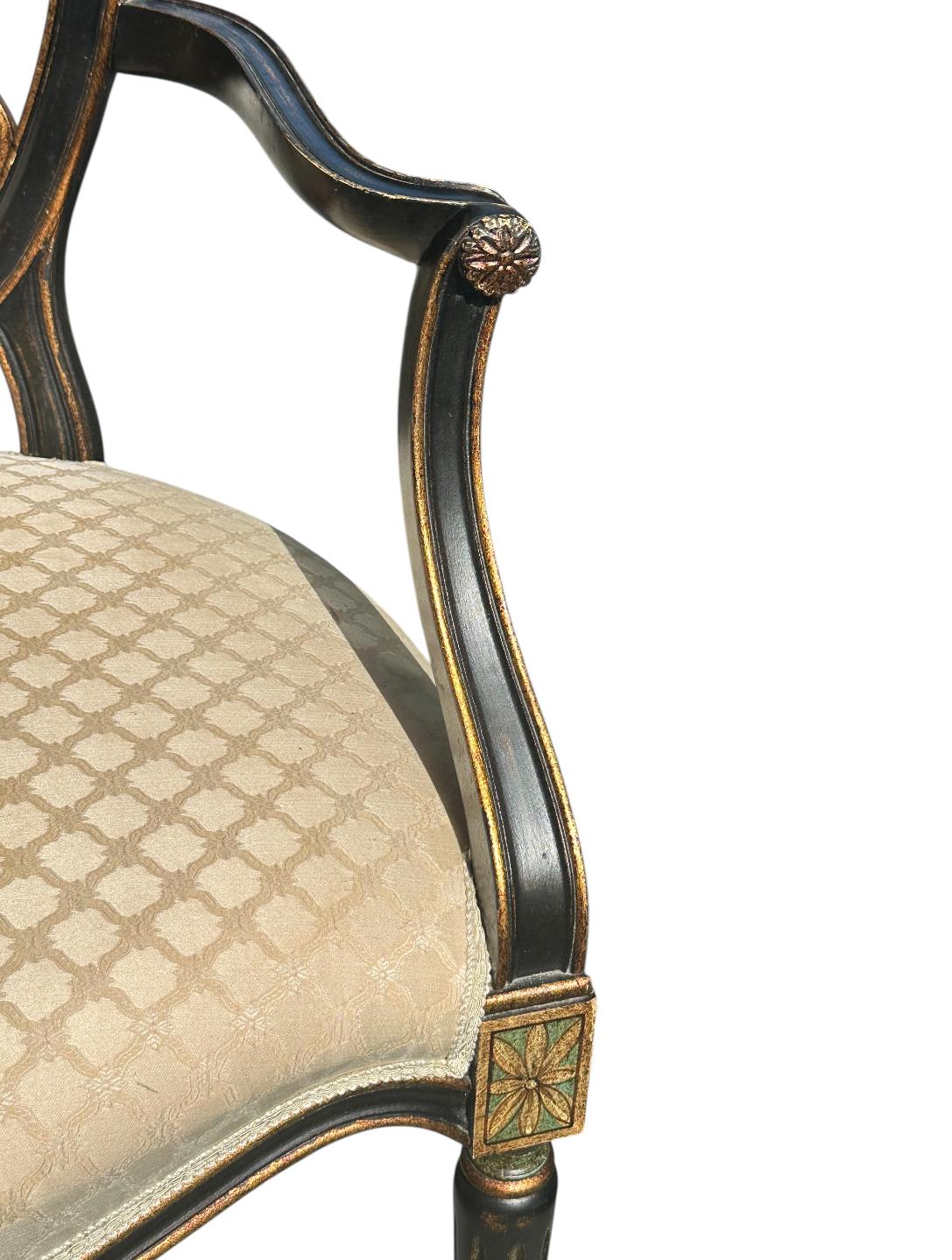 Stunning set of four Italian Regency Hepplewhite Adams style hand painted armchairs by Italian Designer Galimberti Lino.  Scrolled open work splat accentuated with hand painted floral decoration in green with gilt accents on black. The generous