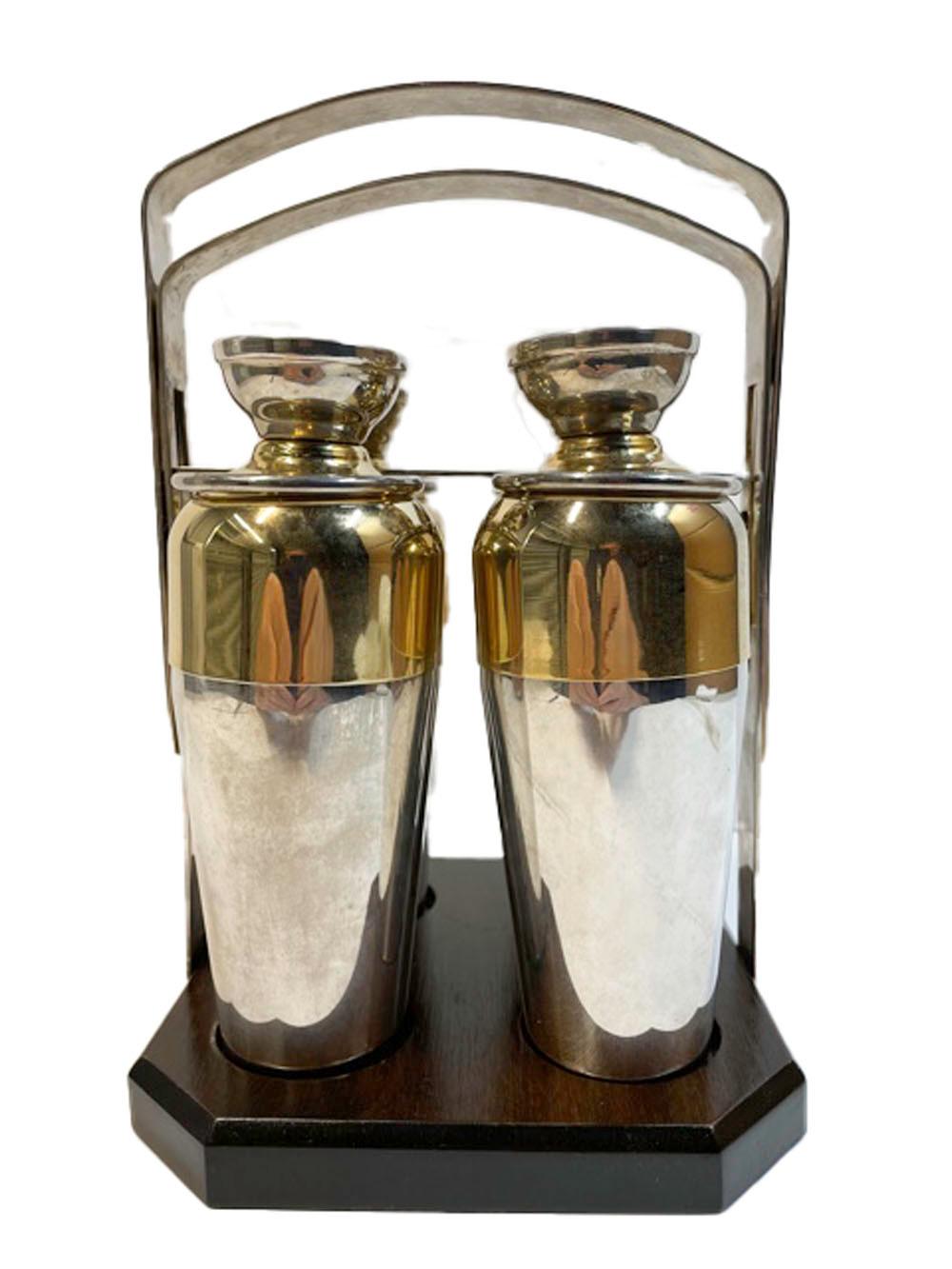 Mid-century silver plate and gilt individual size cocktail shakers with drink indicators on the tops in a silver plate and wood mechanical caddy. The four, single drink shakers with silver plate bases and gilded tops with dial-a-drink indicator in
