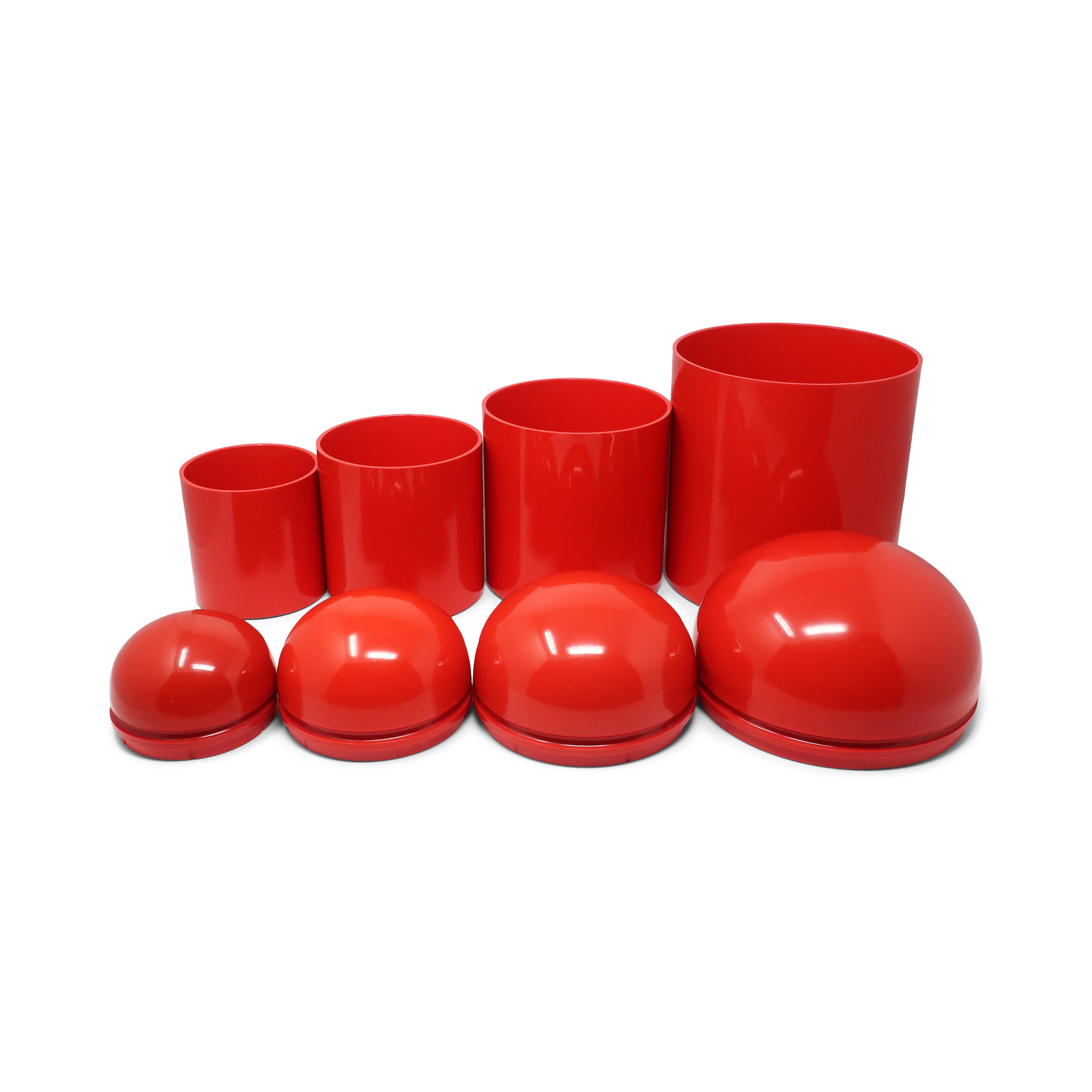 A fantastic and rare set of four 1970s nesting domed containers by Anna Castelli Ferrieri for Kartell in red.  The series was originally sold with cylindrical bases and domed lids as separate items, with both pieces made from injection molded ABS. 