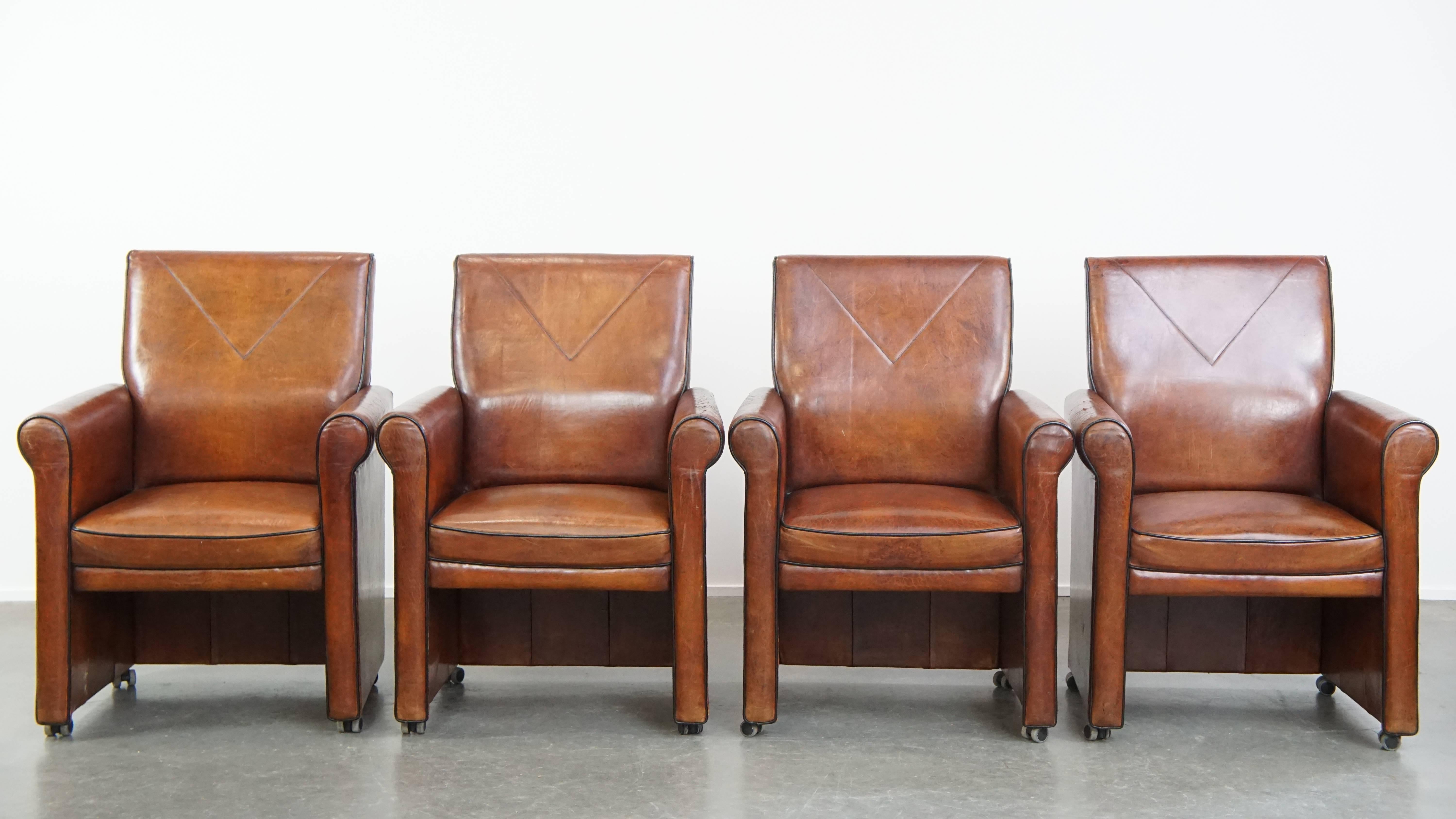 Offered here is a vintage set of four sheepskin dining chairs with black piping and castors, exuding a rich and characterful appearance.

These stylish and practical vintage chairs, upholstered in genuine sheepskin, blend effortlessly into nearly