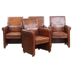Vintage set of 4 sheepskin leather dining chairs on castors