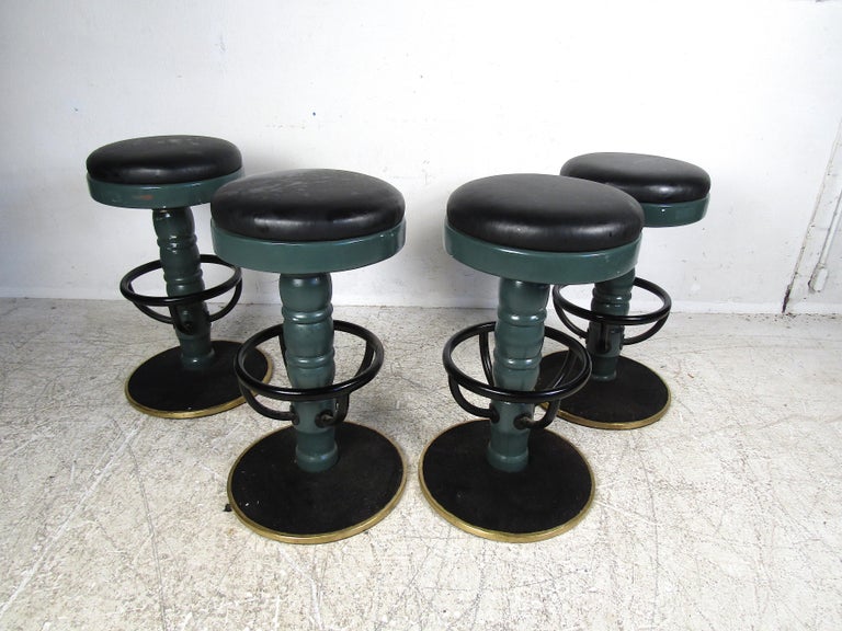 Interesting set of four vintage stools. Brass trim around the bases which are lined with felt. Vinyl upholstery. Please confirm item location with dealer (NJ or NY).