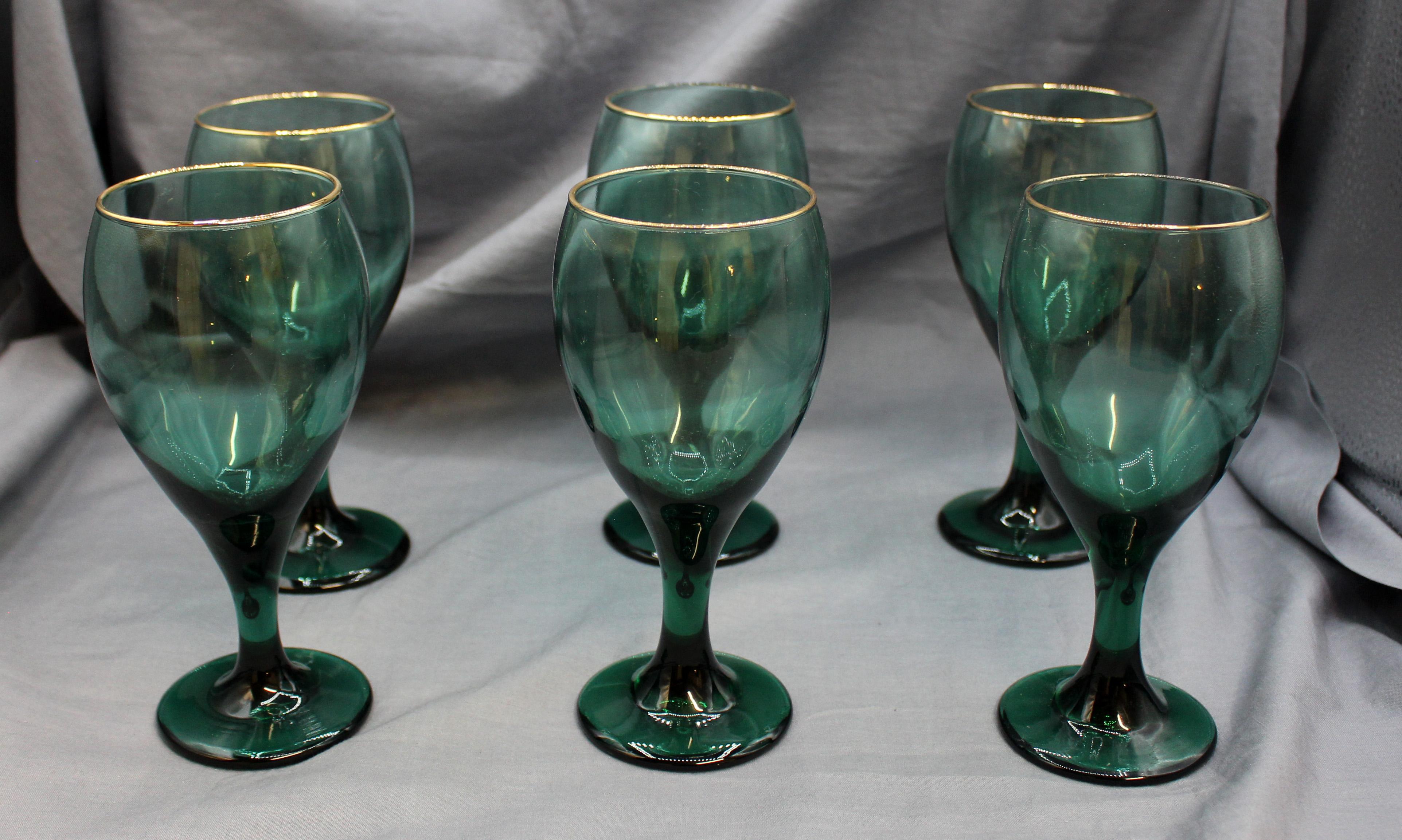 Vintage set of 6 signed Libbey sea foam green wine glasses with 22karat gilt rims. This mark introduced in 1955, cursive L in simple circle. Note the rim appears to be applied in solid gold.
6 7/8