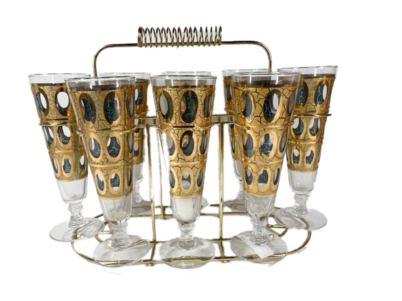 Mid-century pilsner glasses in the Pisa pattern by Culver Glass Co., together with a hard-to-find pilsner caddy. The Pisa pattern has rows of ovel openings in 22 karat gold with a crackled surface over translucent green enamel, allowing the green to
