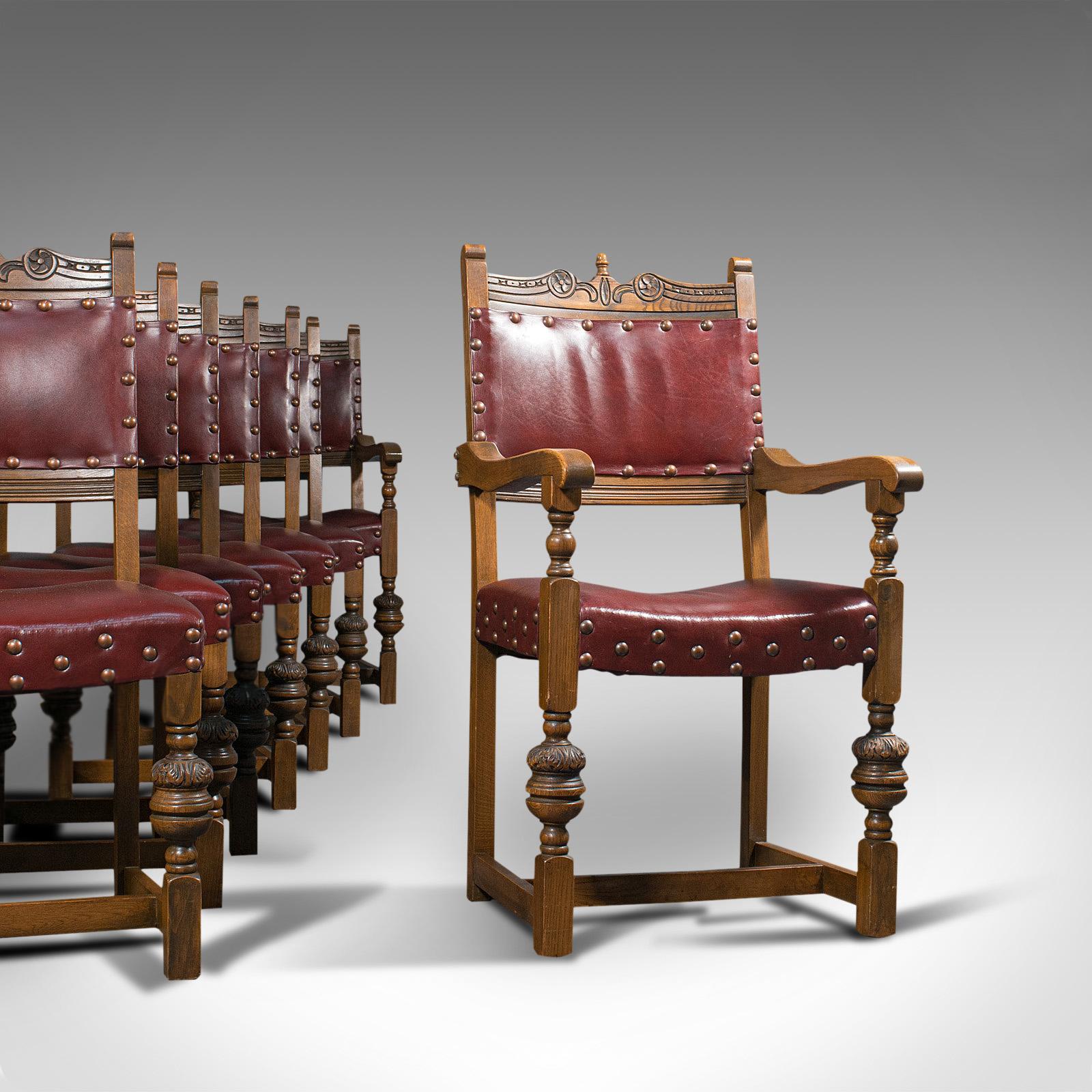 This is a vintage set of 8 dining chairs. An English, quality oak and leather suite in Carolean revival taste, dating to the mid-20th century, circa 1950.

Wonderfully regal dining room set
Pair of dashing carvers for the heads of the
