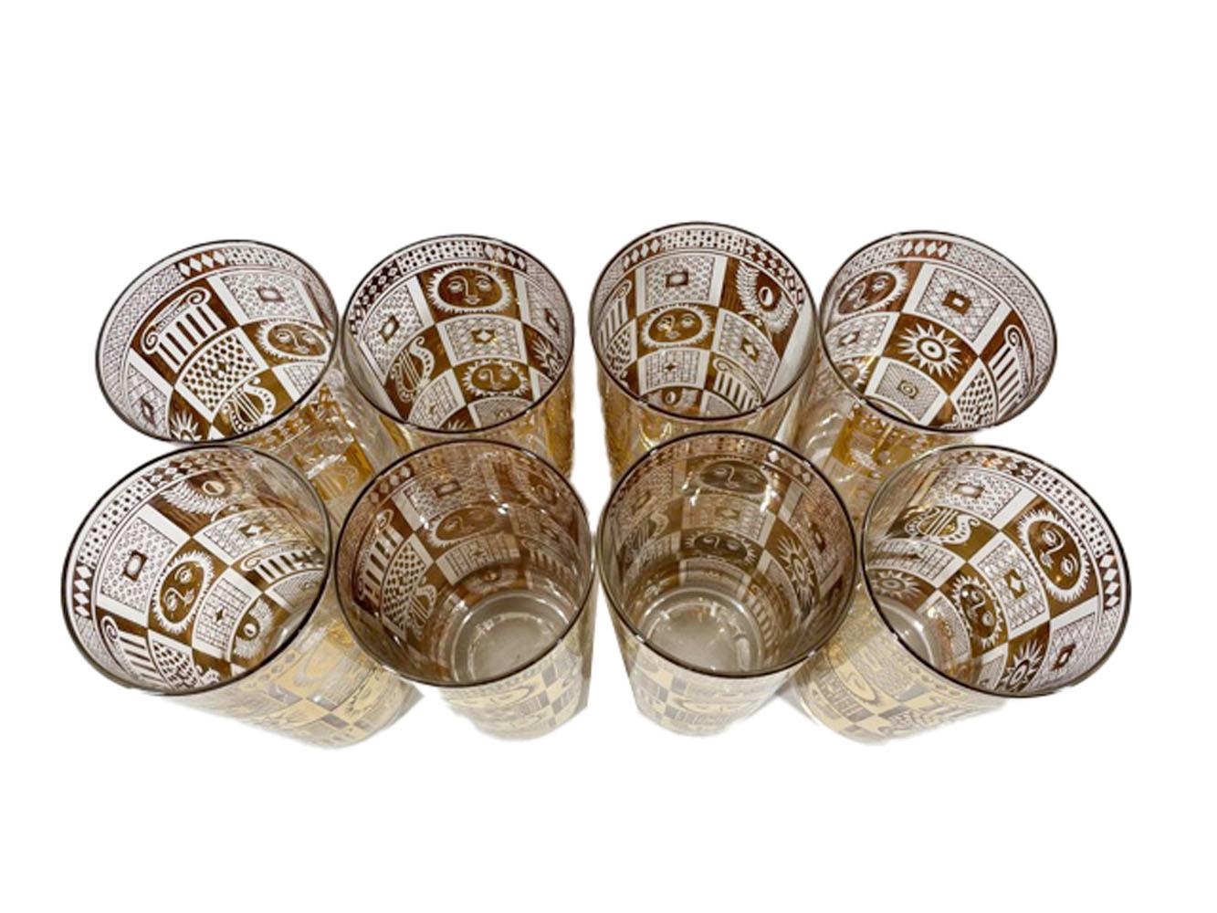 Eight mid-century highball glasses designed by Georges Briard in the Golden Celeste pattern having a checkerboard pattern in 22 karat gold on clear glass and each square containing classical motifs including suns with faces, column capitals and
