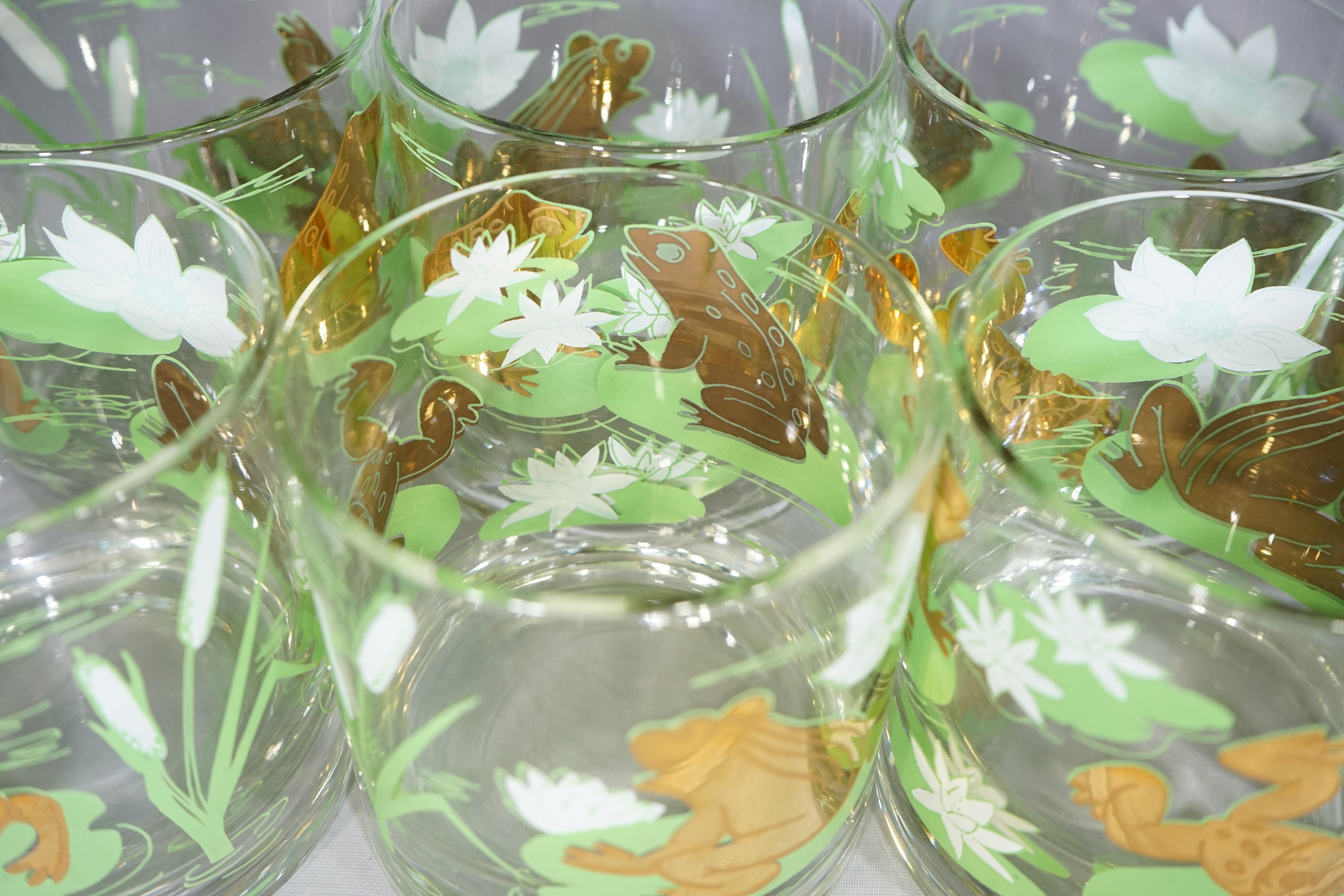 Set of eight vintage old fashioned glasses featuring gold frogs with green and white lily pads design.