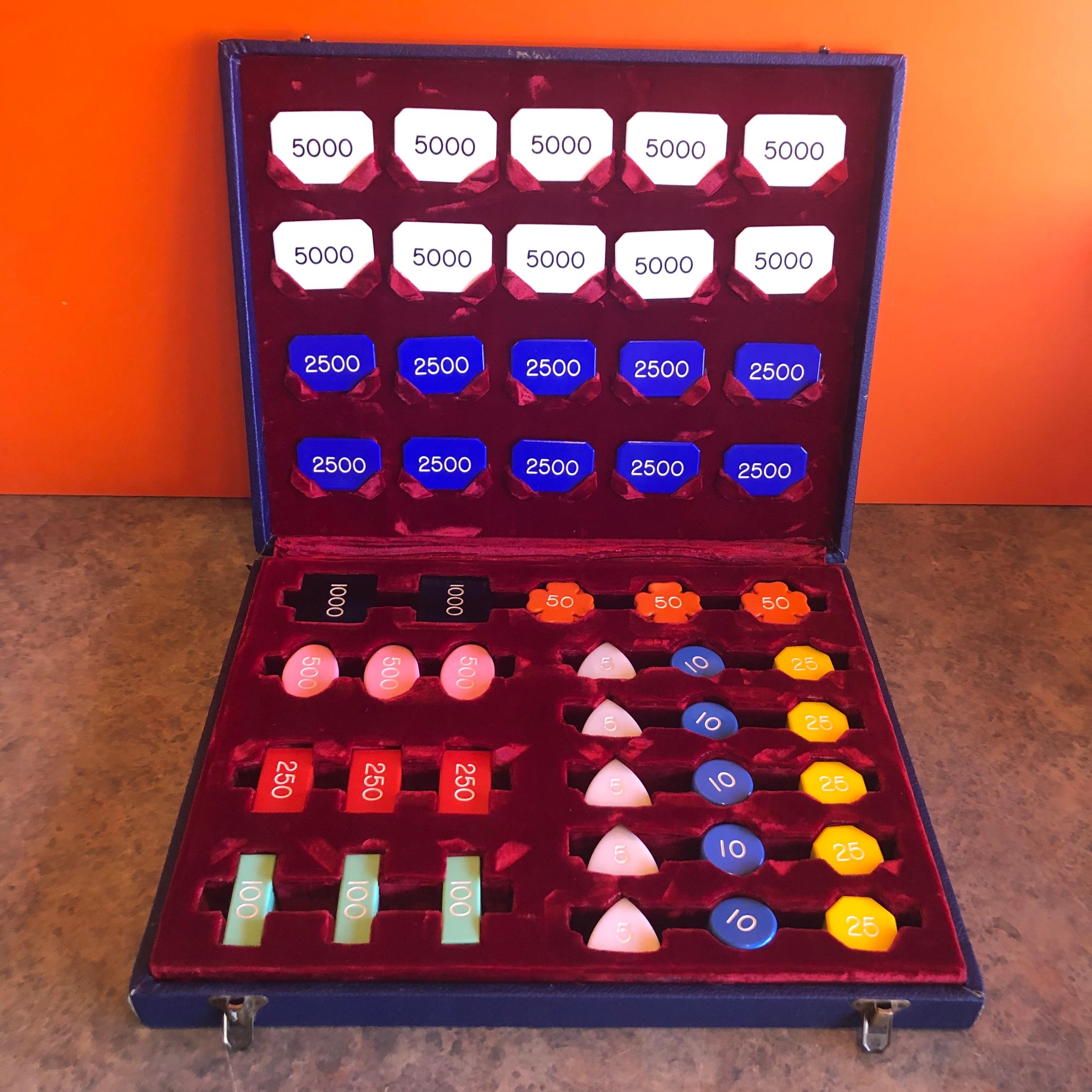 Vintage set of baccarat or poker chips and markers in a blue custom case with red crushed velvet storage departments by Cheney of England, circa 1950s. The set is in very good condition and contains 300 Bakelite 