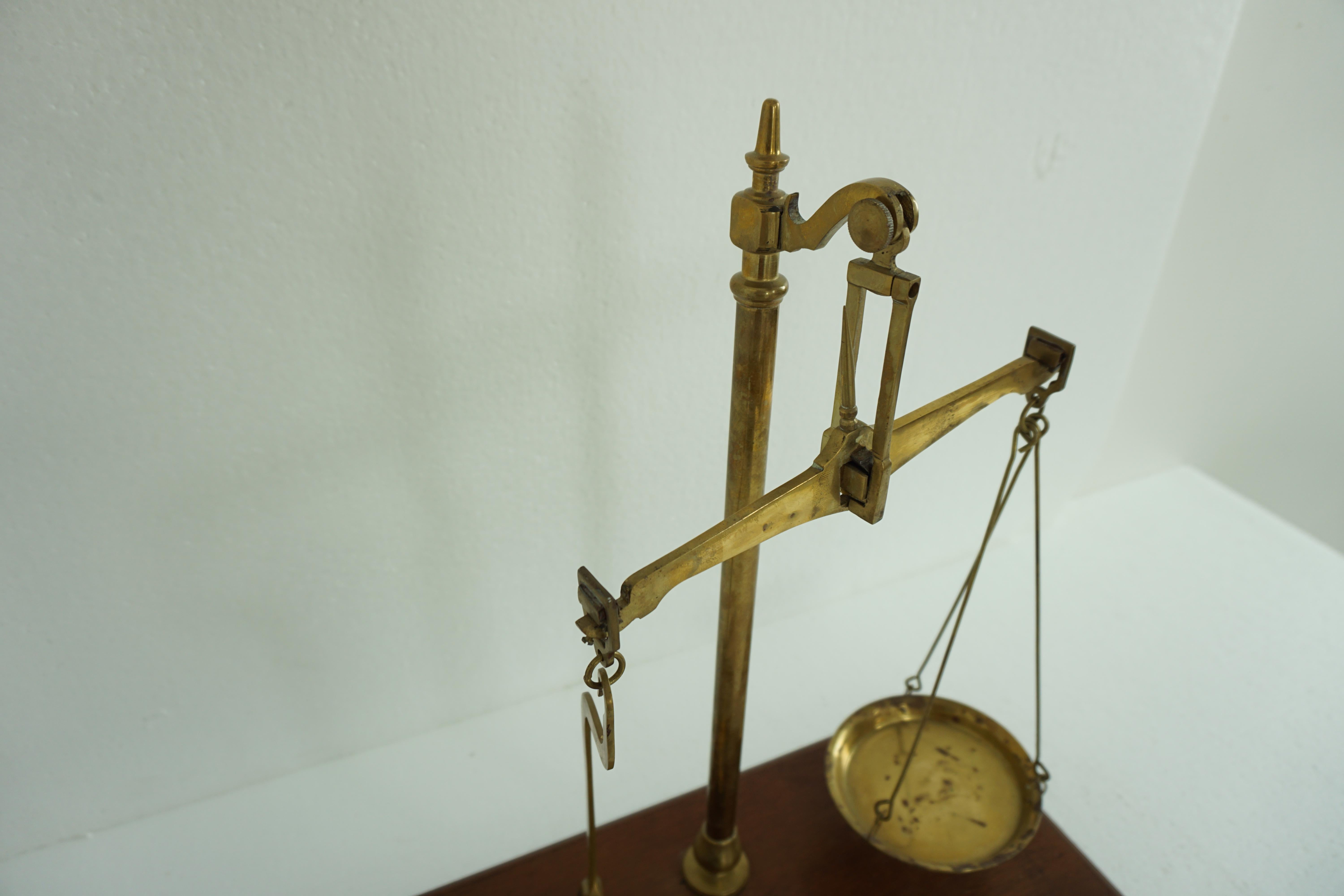Vintage set of brass grocer's dairy scales, Scotland, 1930s, 1967

Scotland,

1930s

All original
Standing on a moulded walnut base
Beam balance scale
All made of solid brass
With a brass produce pan to the left
And another brass holder to the
