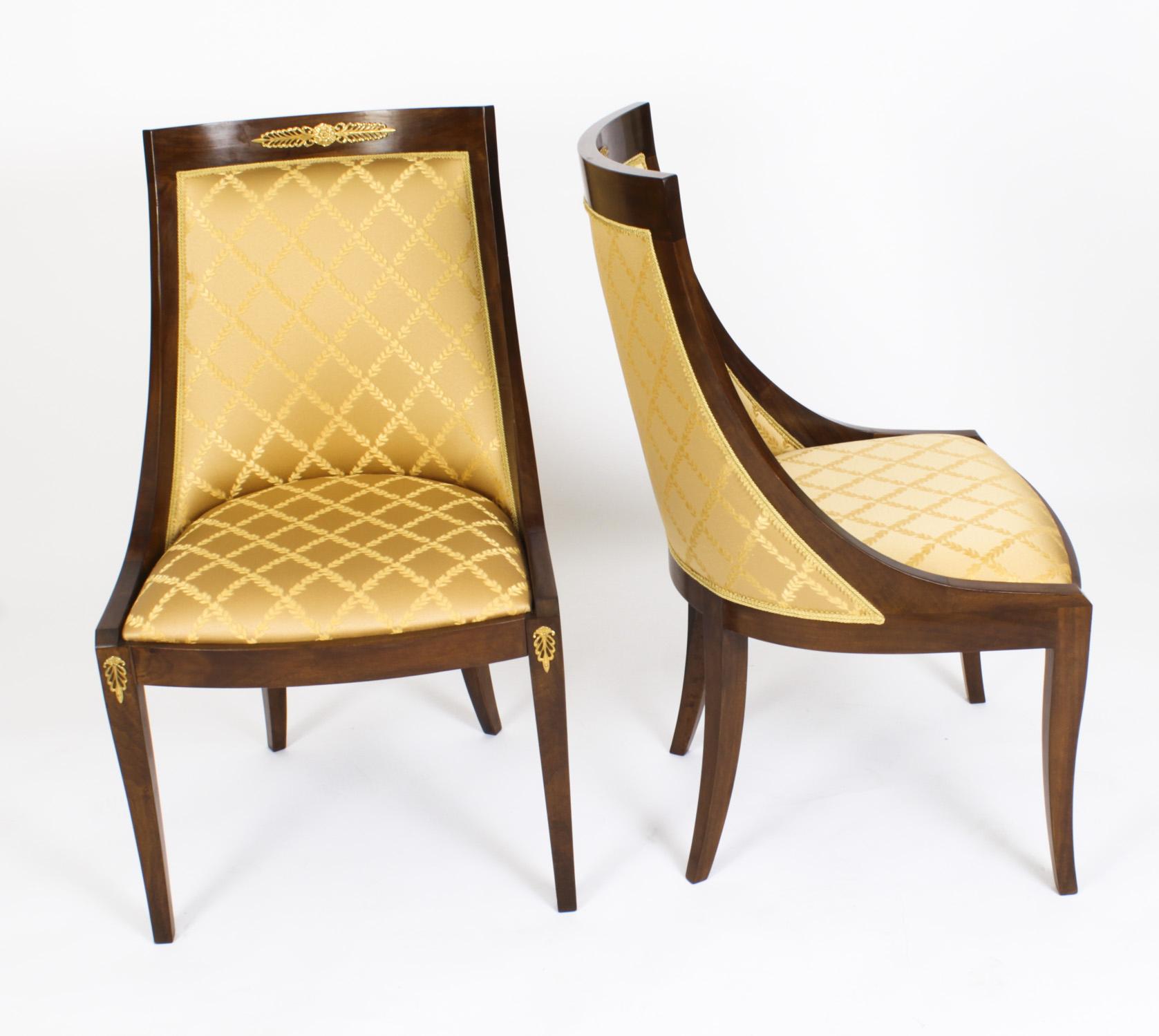 An absolutely fantastic vintage set of eight Empire Revival Gondola dining chairs, dating from the second half of the 20th Century.

The chairs are made from solid walnut that is beautiful in colour and has been embellished with striking ormolu